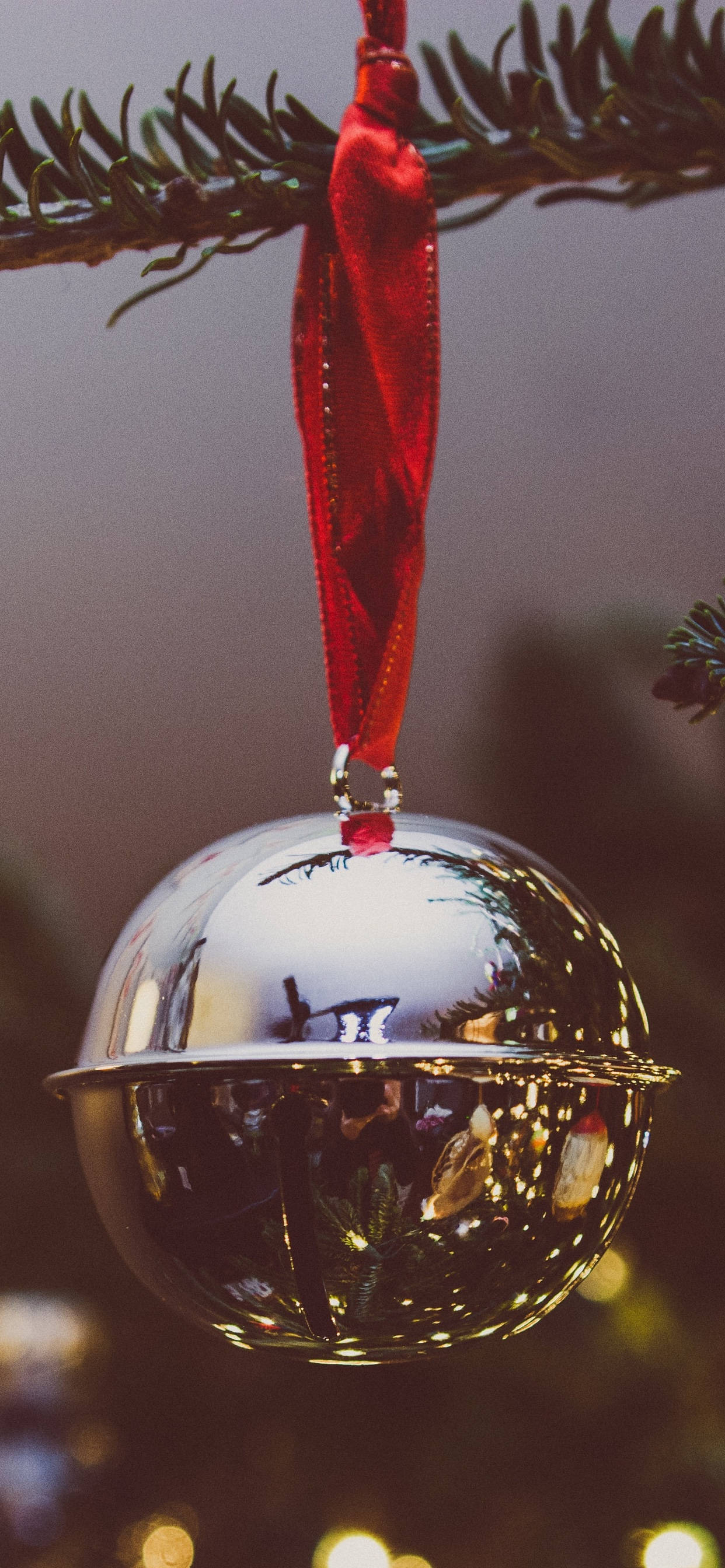 silver Christmas Ball iPhone, shiny silver bell ornament, red ribbon, 2K Phone Wallpaper