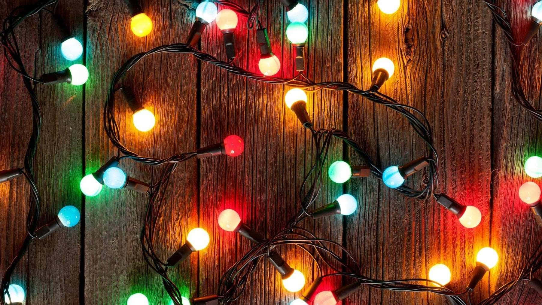 colorful Christmas lights, string lights, rustic wooden background, HD Desktop Wallpaper