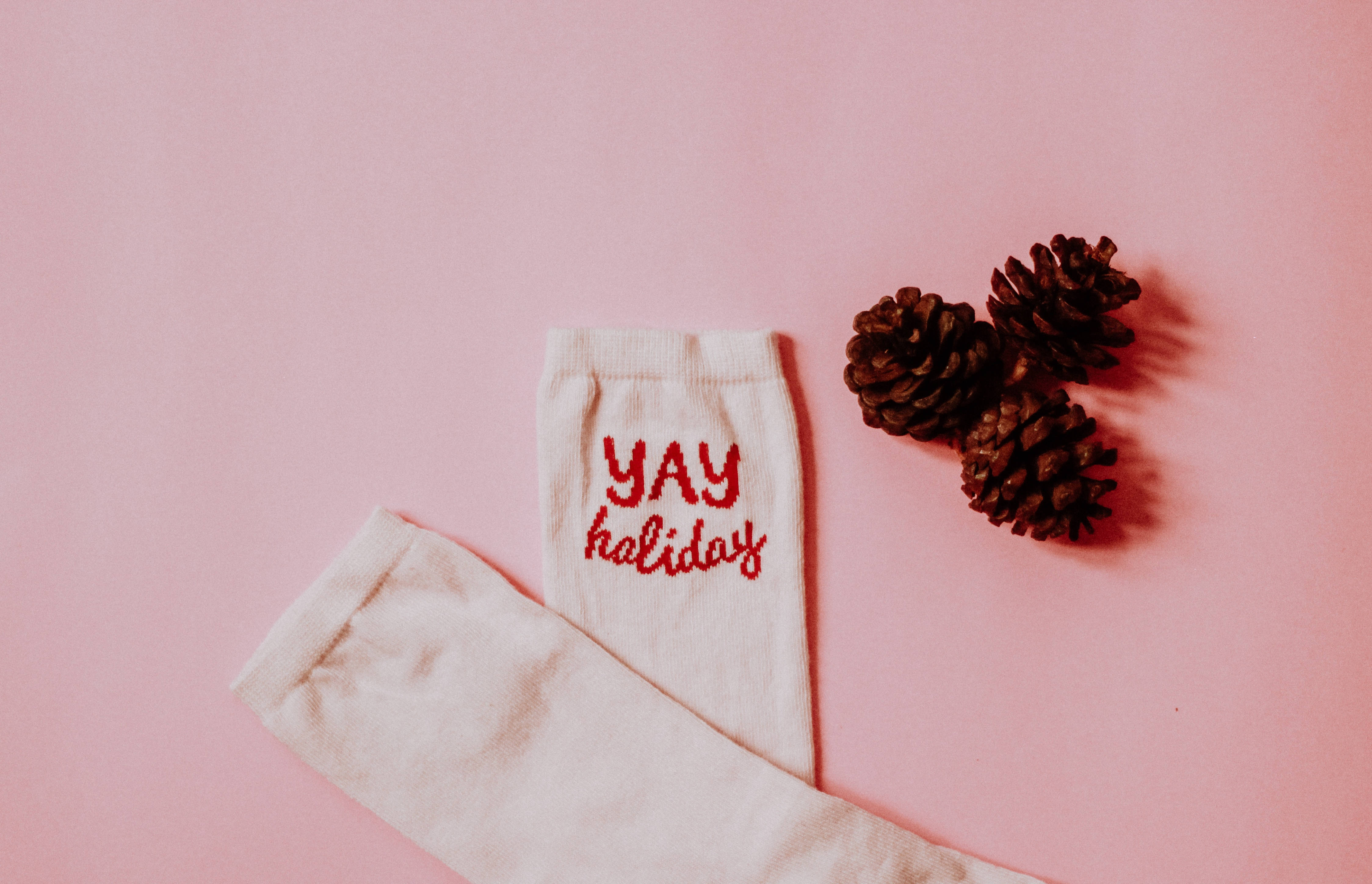 Aesthetic Christmas Socks, red 'YAY holiday' text, three pinecones, 4K Desktop Wallpaper