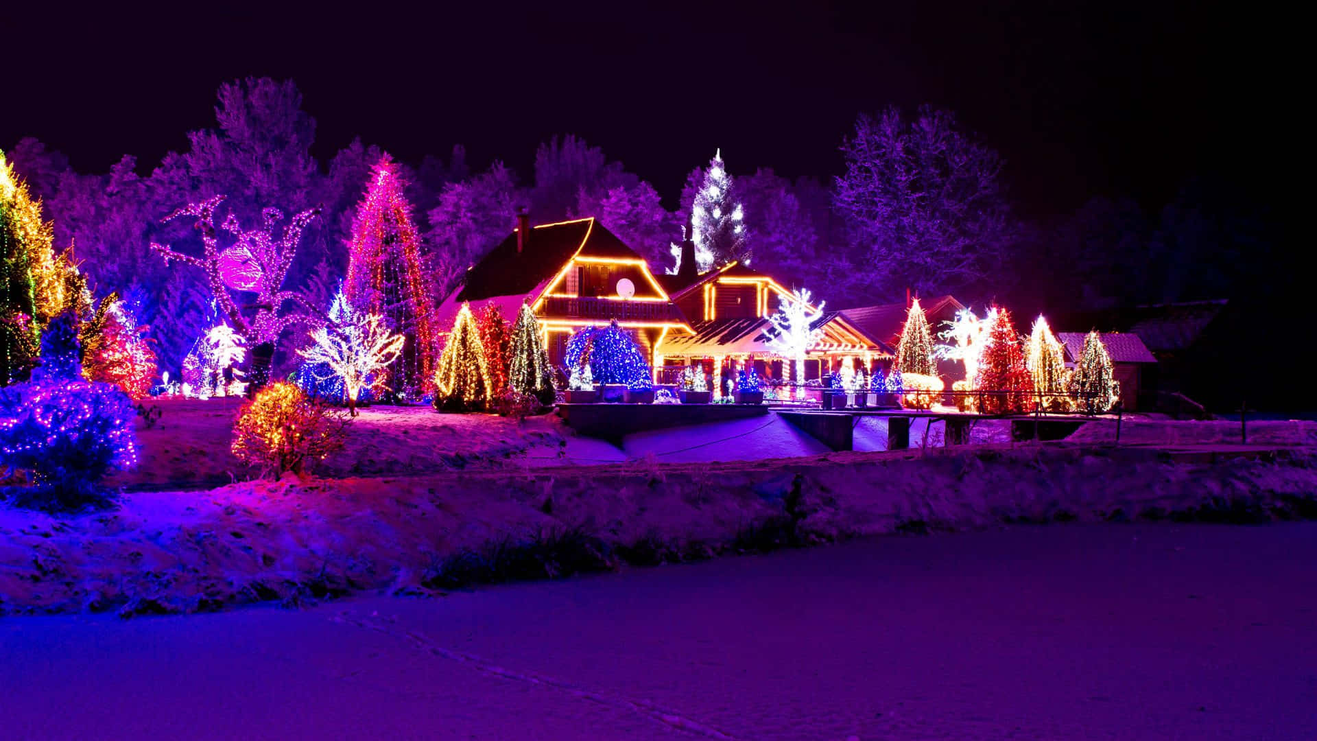 Christmas Village, snow-covered house, vibrant purple orange and blue holiday lights, Full HD Desktop Wallpaper