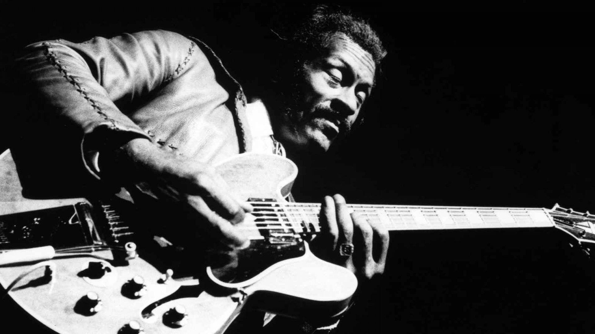 Chuck Berry, electric guitar, dramatic stage lighting, Full HD Desktop Wallpaper