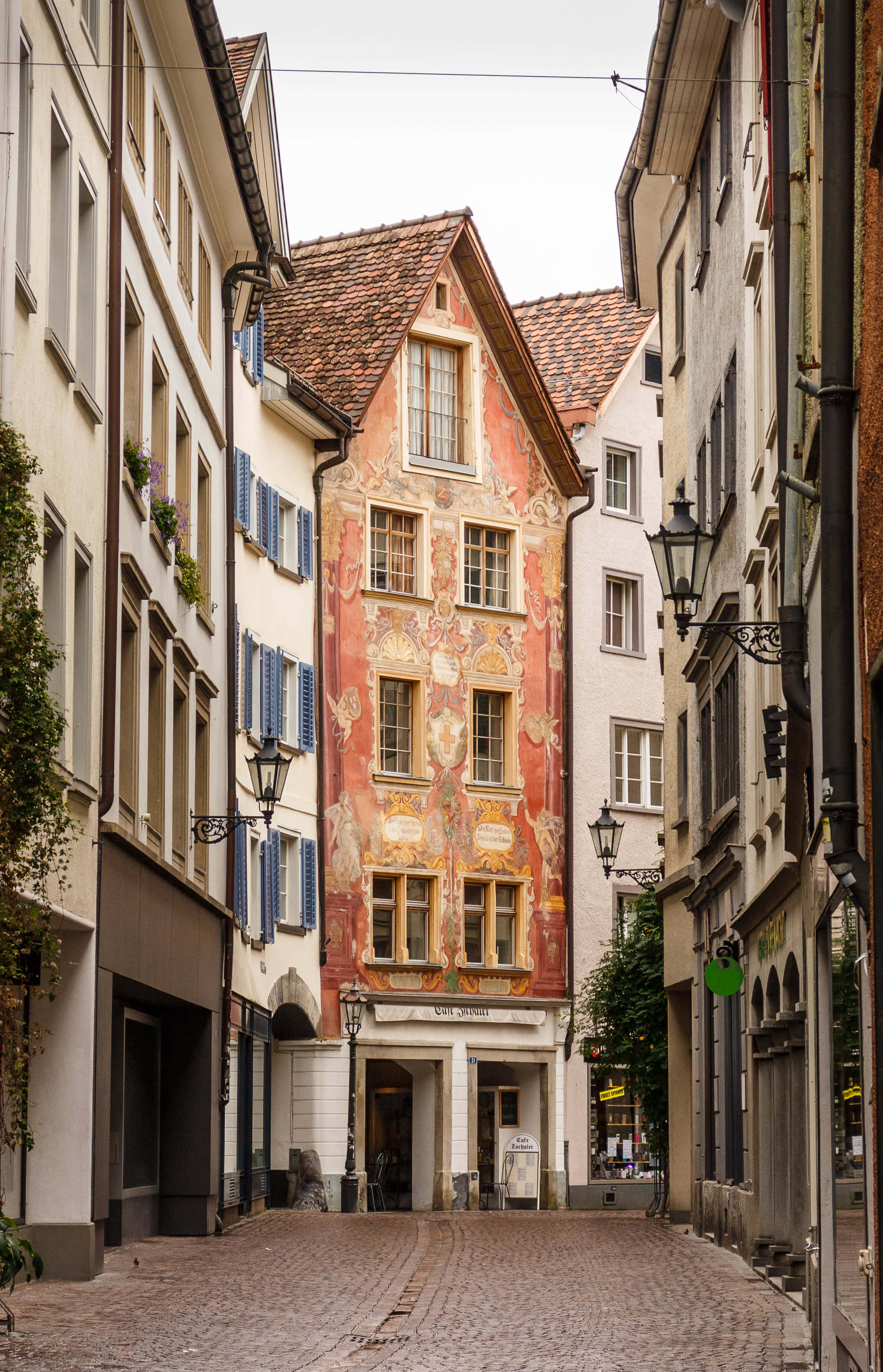Chur, historic painted building, vibrant red frescoes, 2K Phone Wallpaper