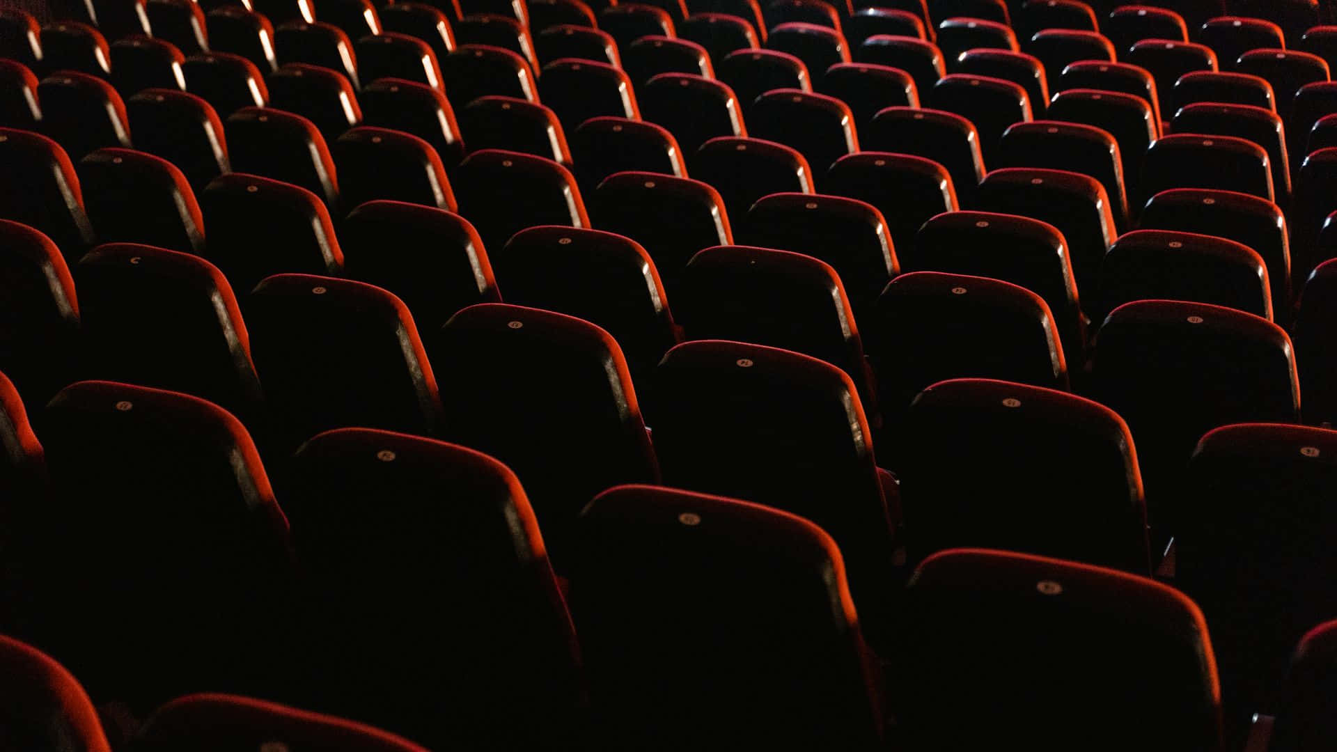 red theater seats, dim lighting, quiet anticipatory atmosphere, Full HD Desktop Wallpaper