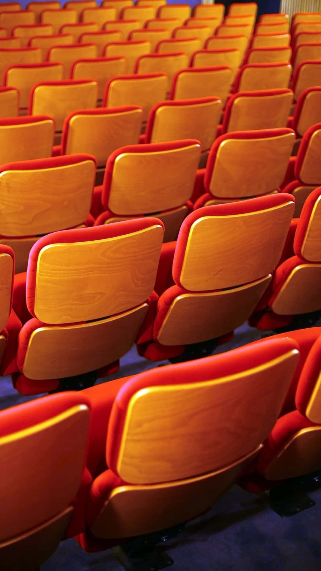 red theater seats, wood theater seats, warm stage lighting, Full HD Phone Wallpaper