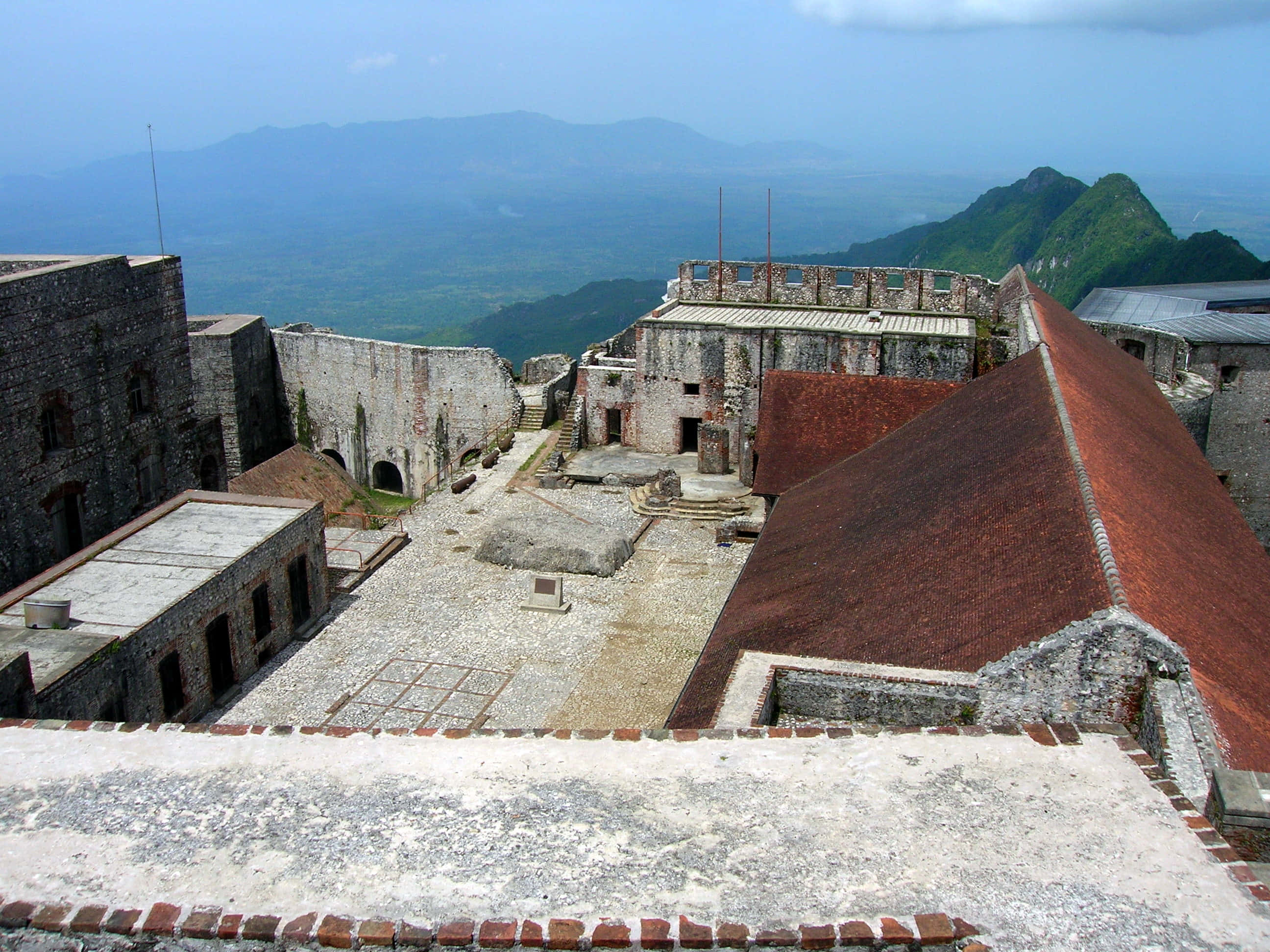 Citadelle Laferriere, foggy backdrop, weathered stone fortress courtyard, 2K Desktop Wallpaper