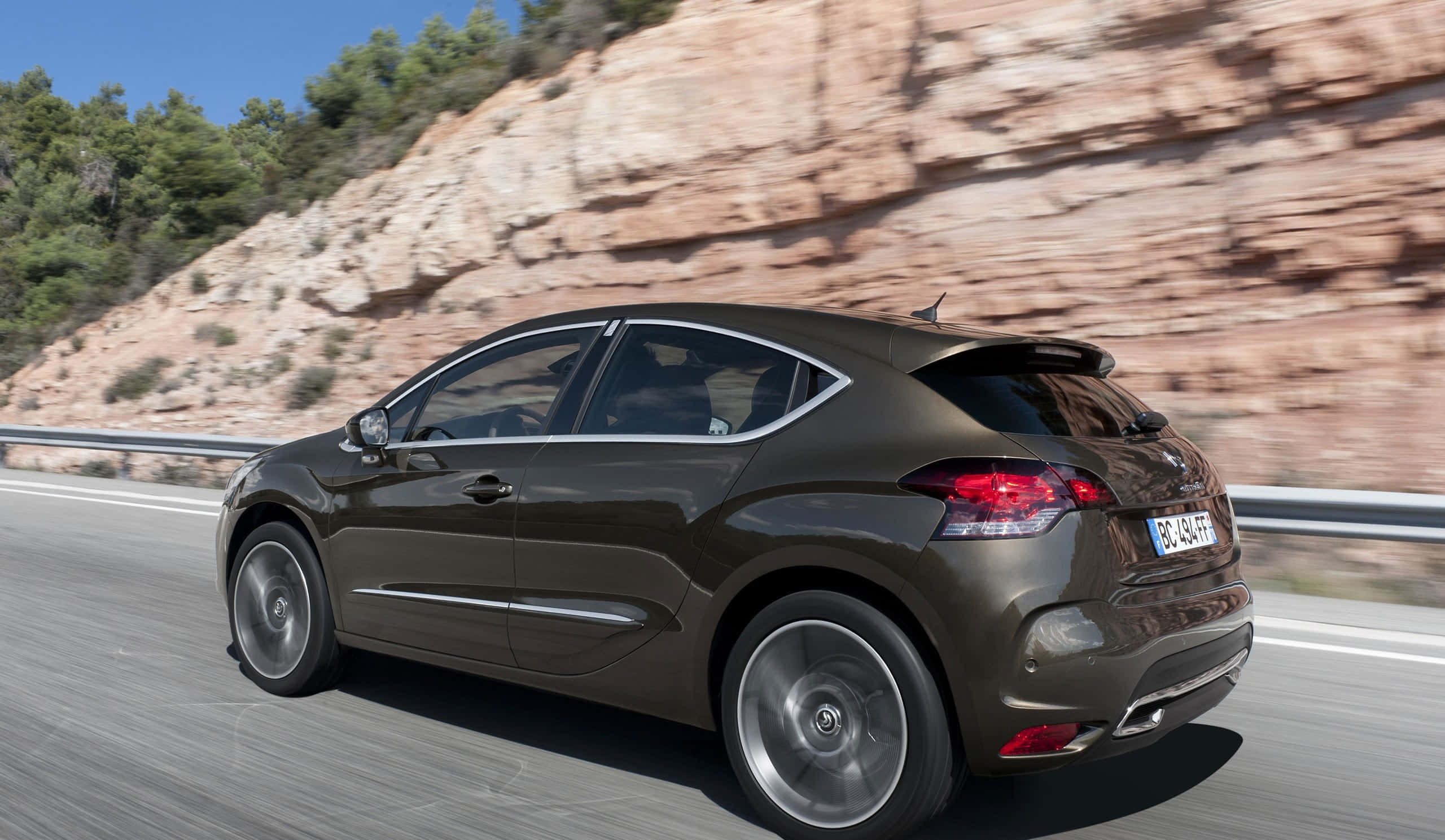 Citroen DS4, sleek brown hatchback, winding mountain road, 2K Desktop Wallpaper