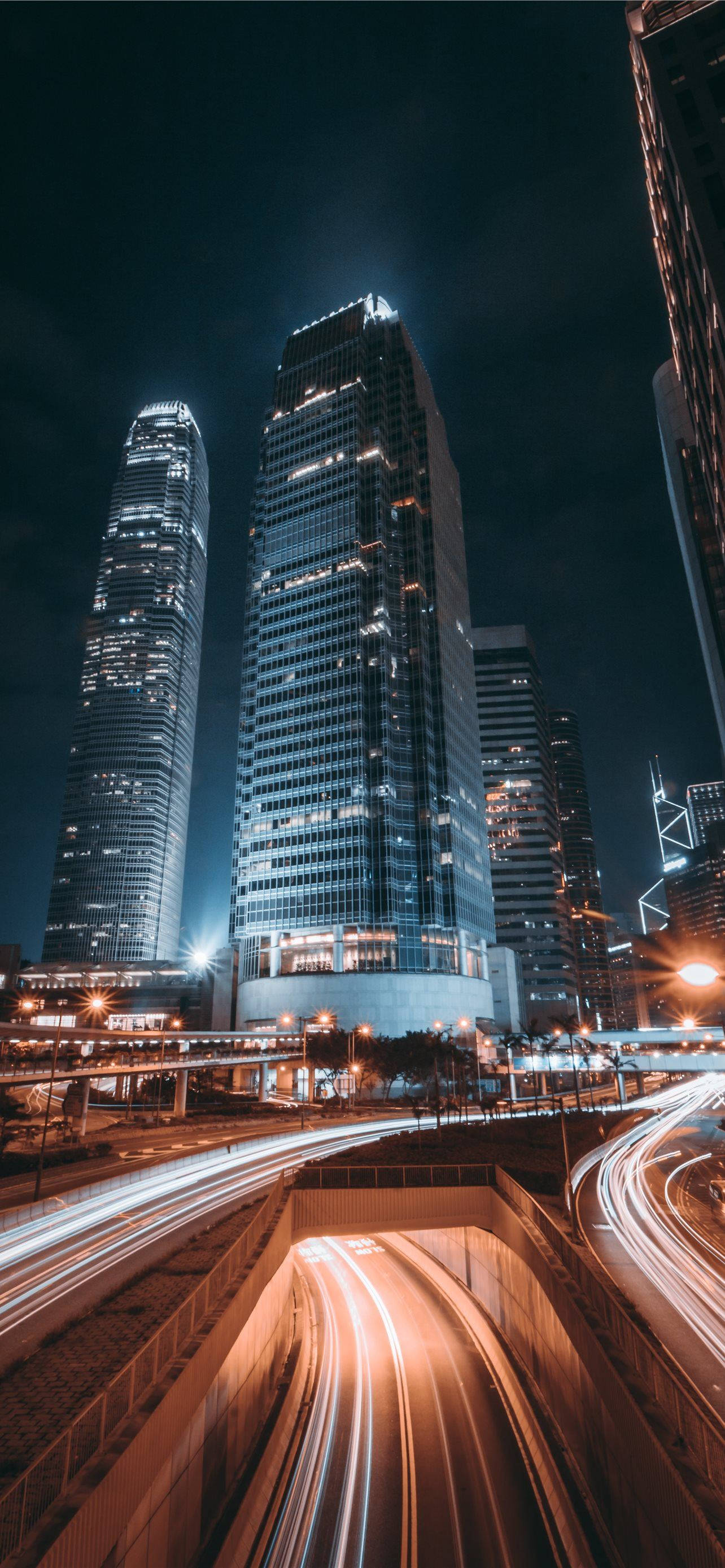 Night City, towering skyscrapers, glowing light trails, 2K Phone Wallpaper