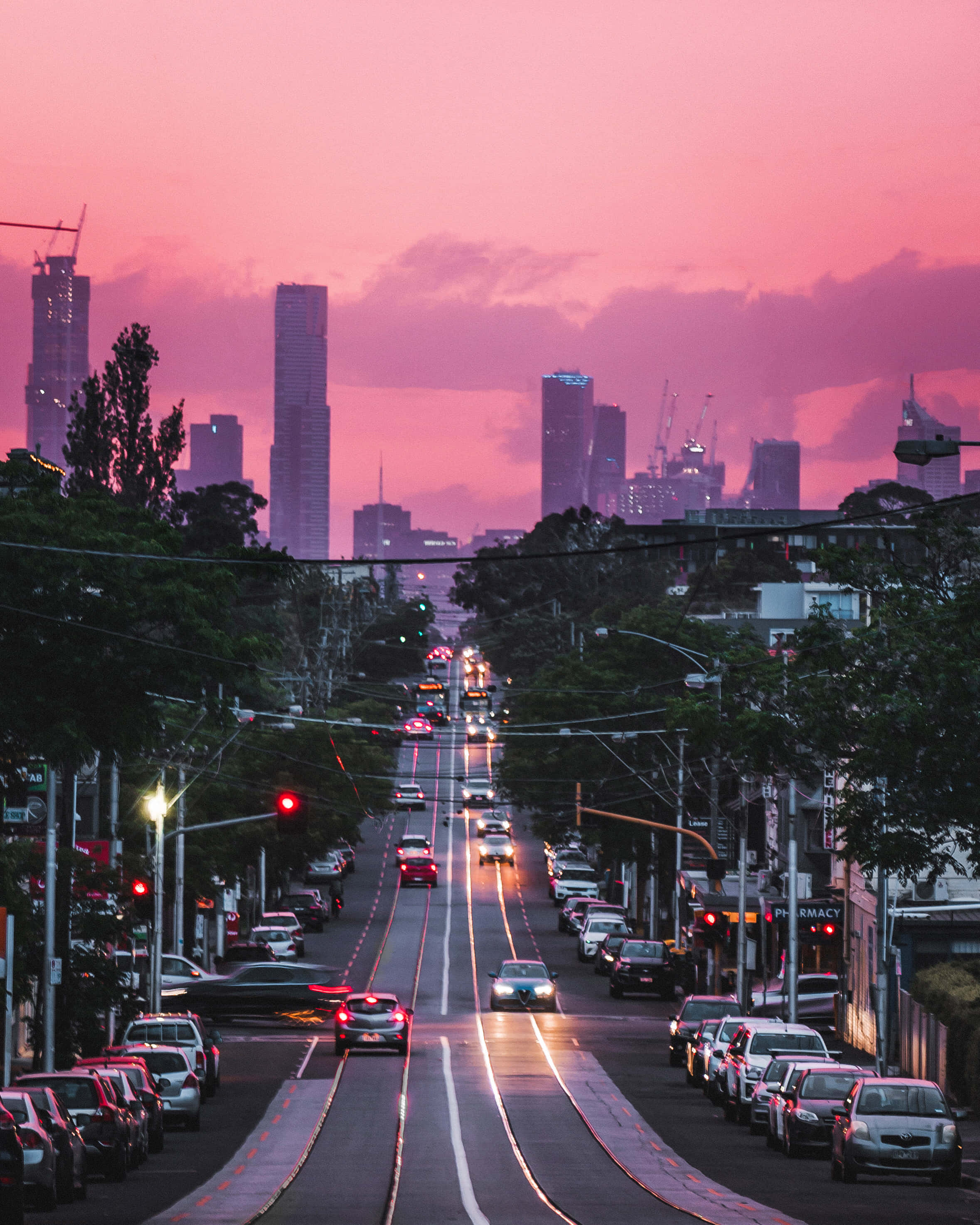 Pink City Highway, vibrant pink sunset, bustling city street, 2K Phone Wallpaper