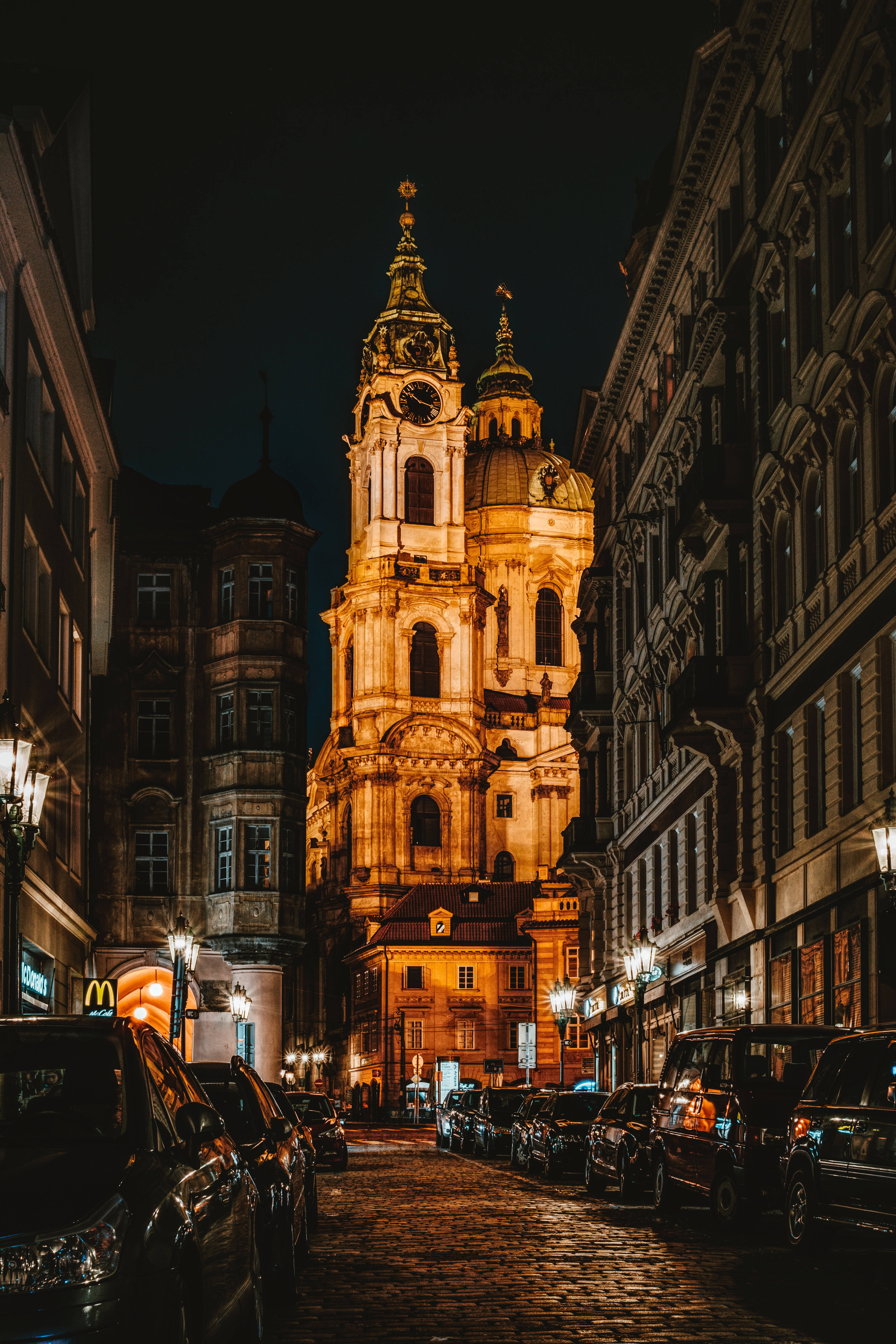 Night City, illuminated church tower, narrow cobblestone street, 5K Phone Wallpaper