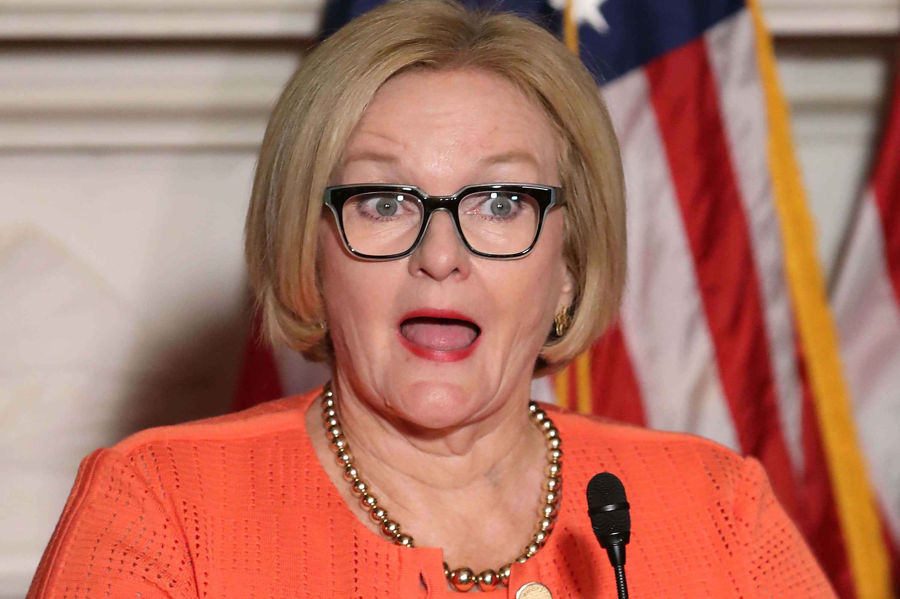 Claire McCaskill, orange blouse, black glasses, 2K Desktop Wallpaper