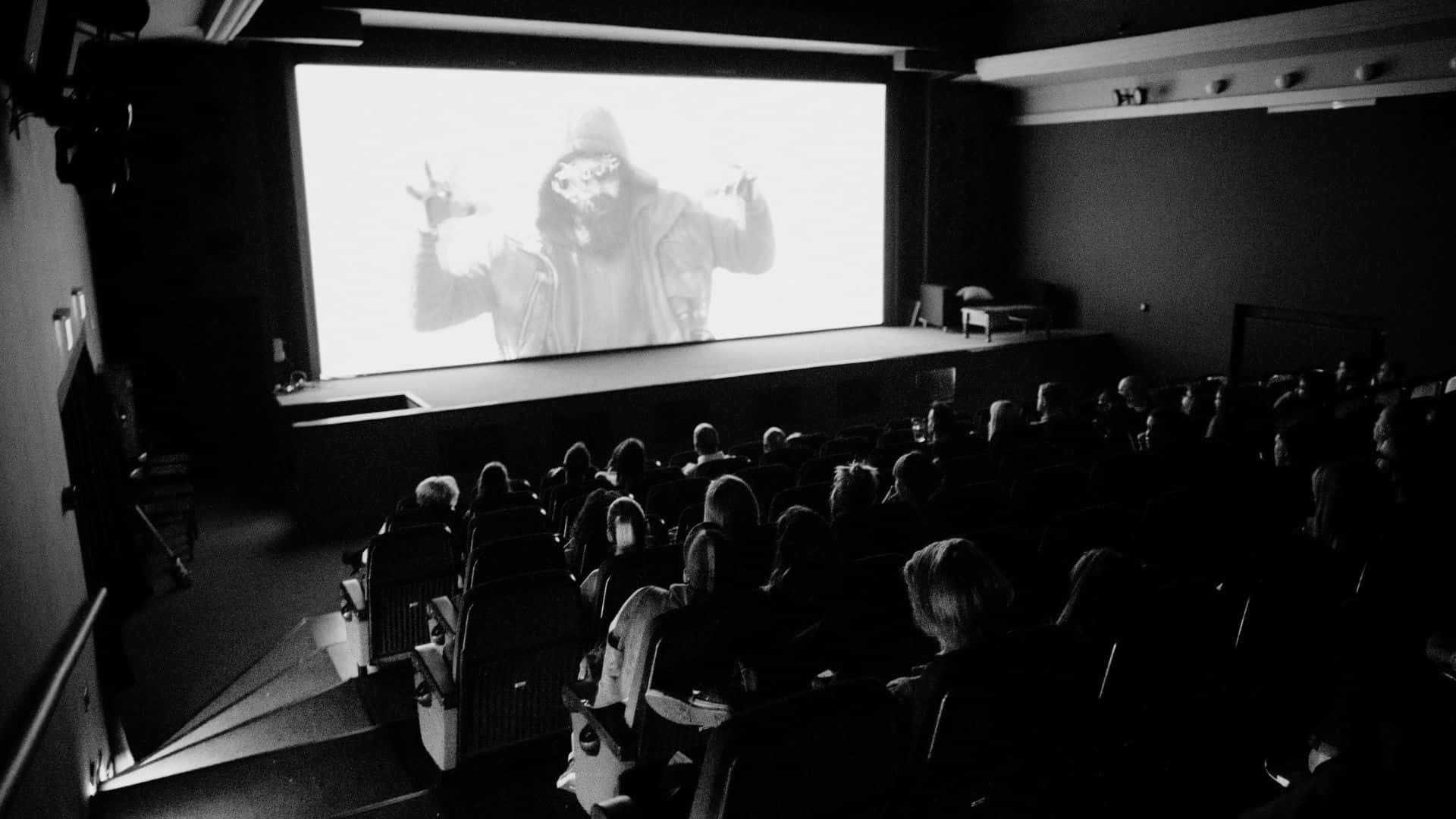 black and white movie, hooded figure, dimly lit theater, Full HD Desktop Wallpaper