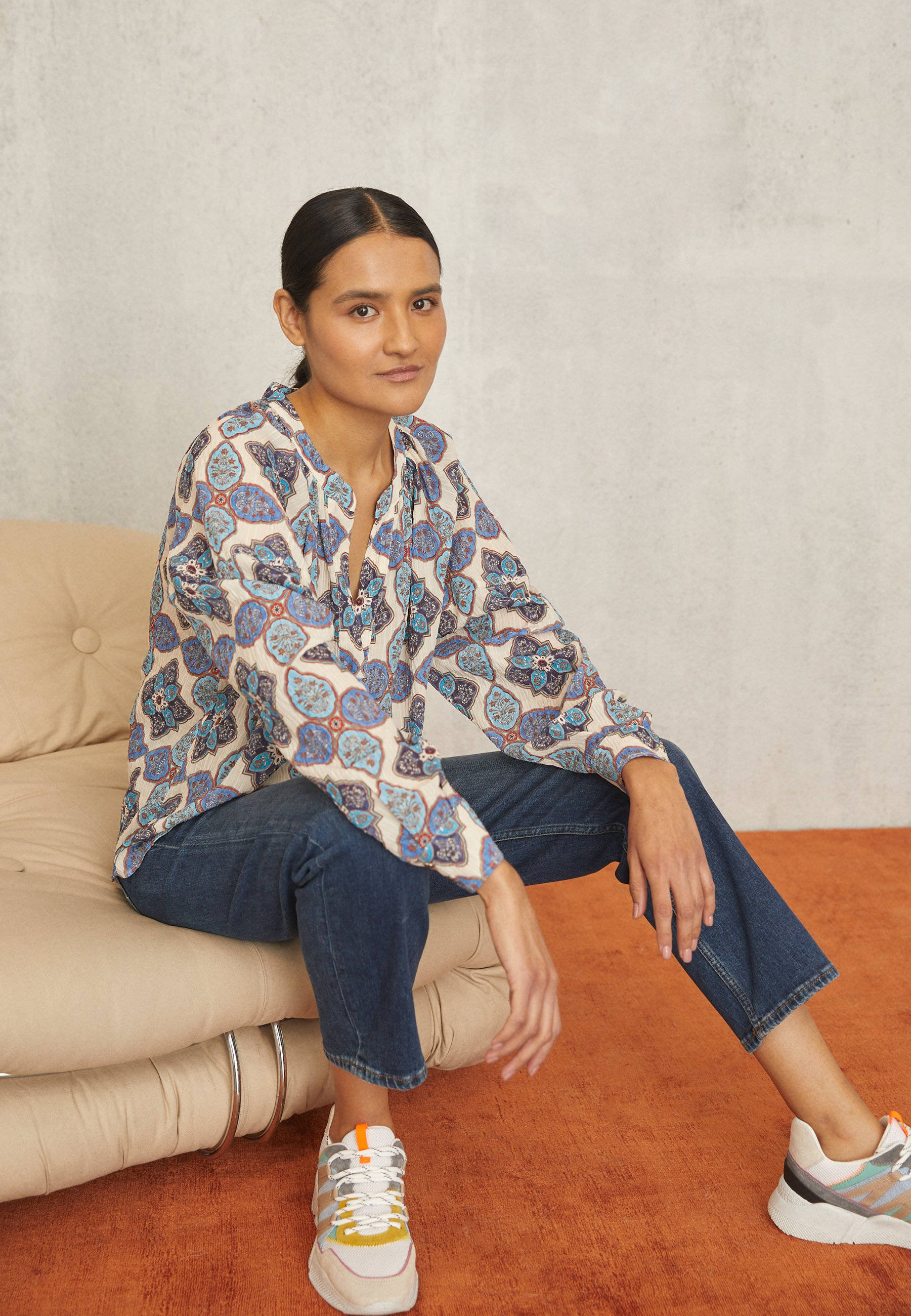 Claudie Pierlot, colorful patterned top, beige sofa, 2K Phone Wallpaper