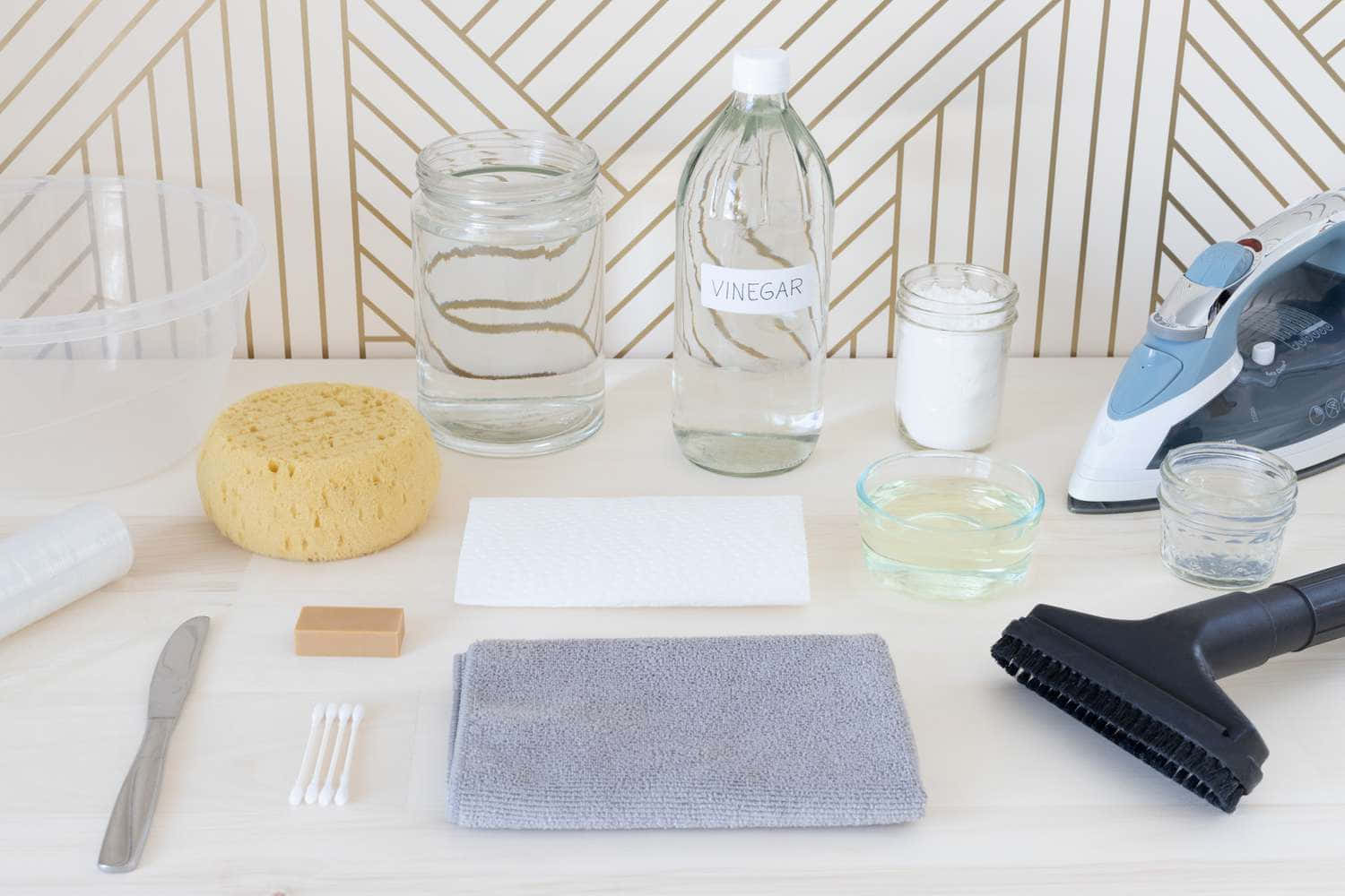 cleaning essentials tools, geometric gold and white wallpaper, clean organized table, HD Desktop Wallpaper