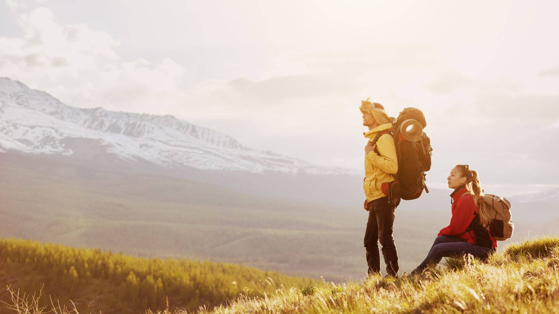 mountaineering couple, grassy hill, snow-capped mountains, Full HD Desktop Wallpaper