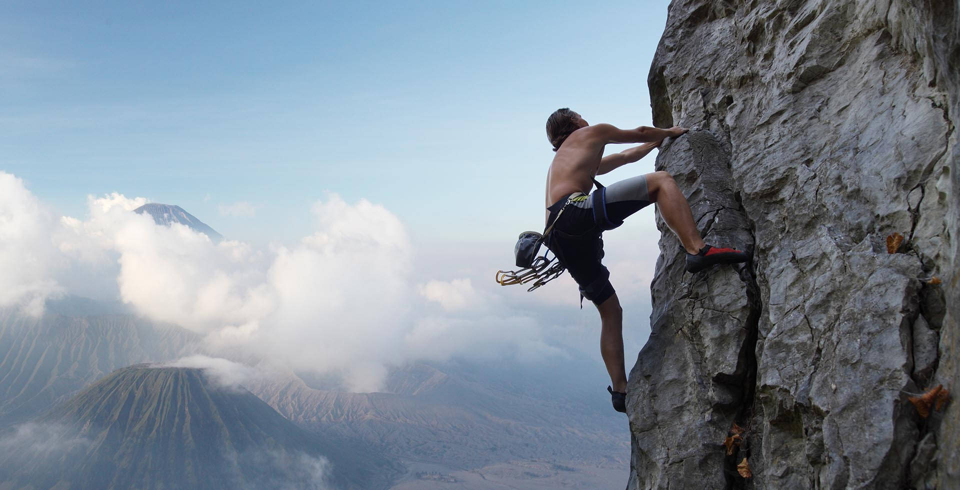 free sport climbing, rugged cliff face, misty volcanic peaks, Full HD Desktop Wallpaper