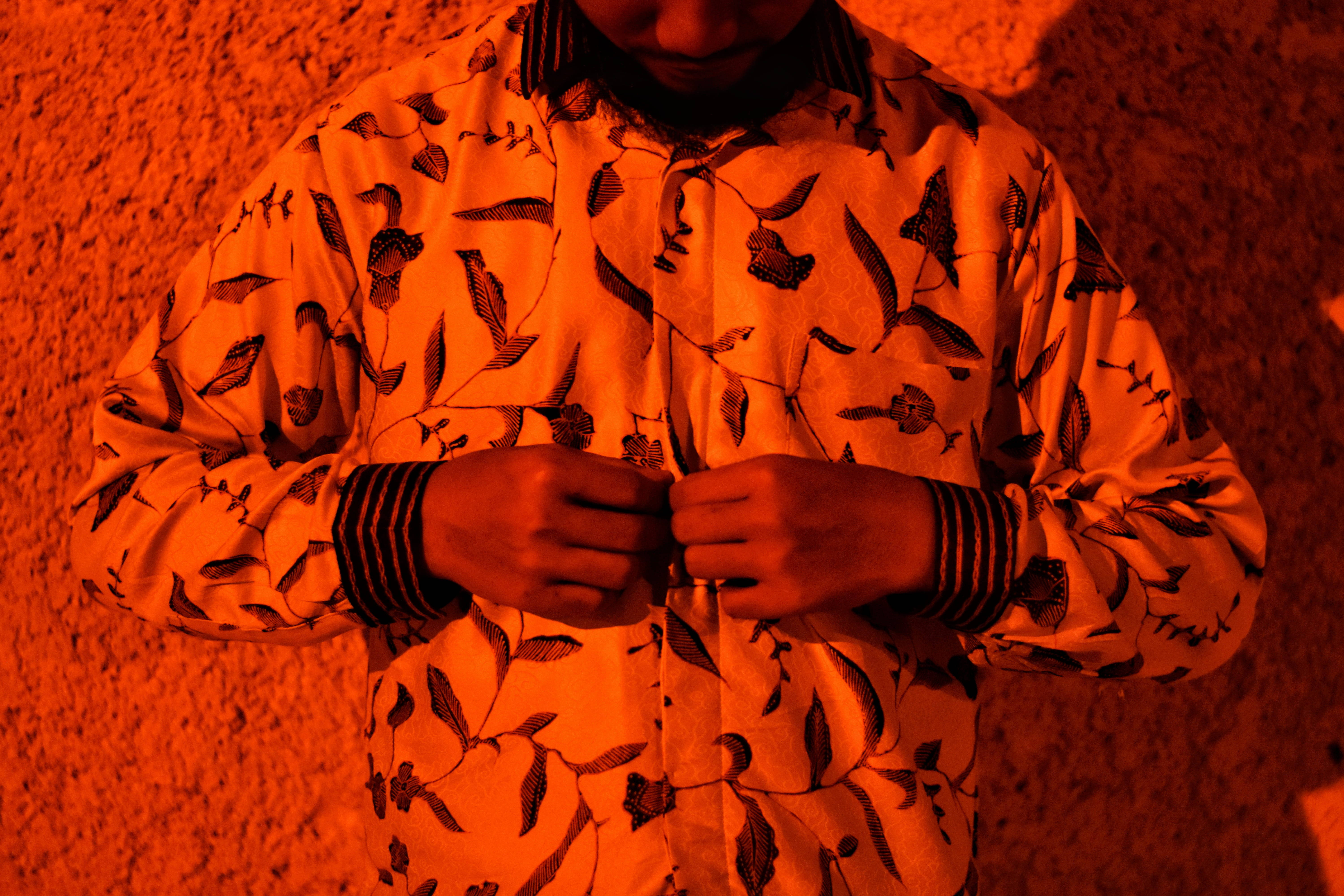 batik jacket, leaf-patterned shirt, intense orange lighting, 5K Desktop Wallpaper