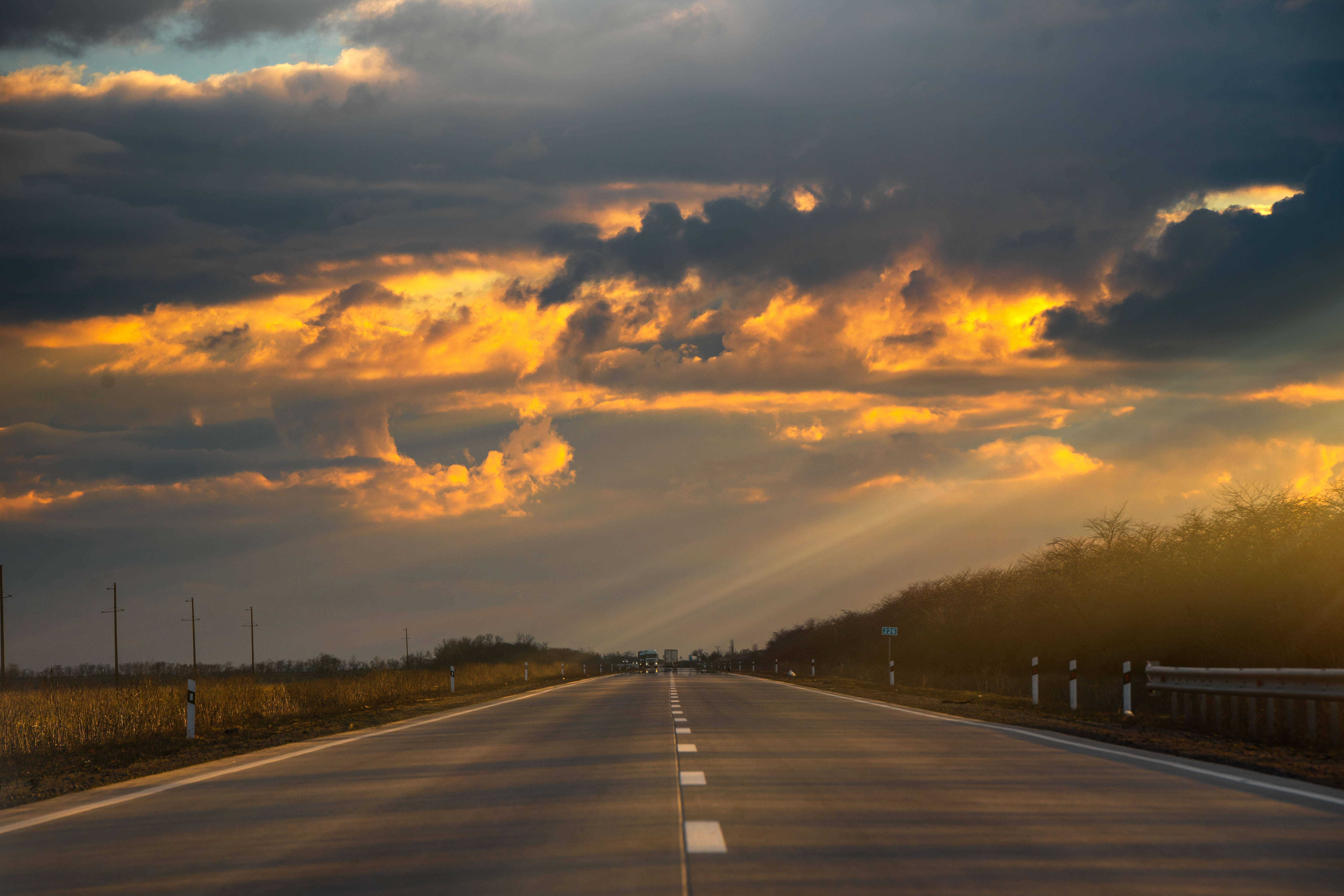 country road, golden sunbeams, dark clouds, 5K Desktop Wallpaper