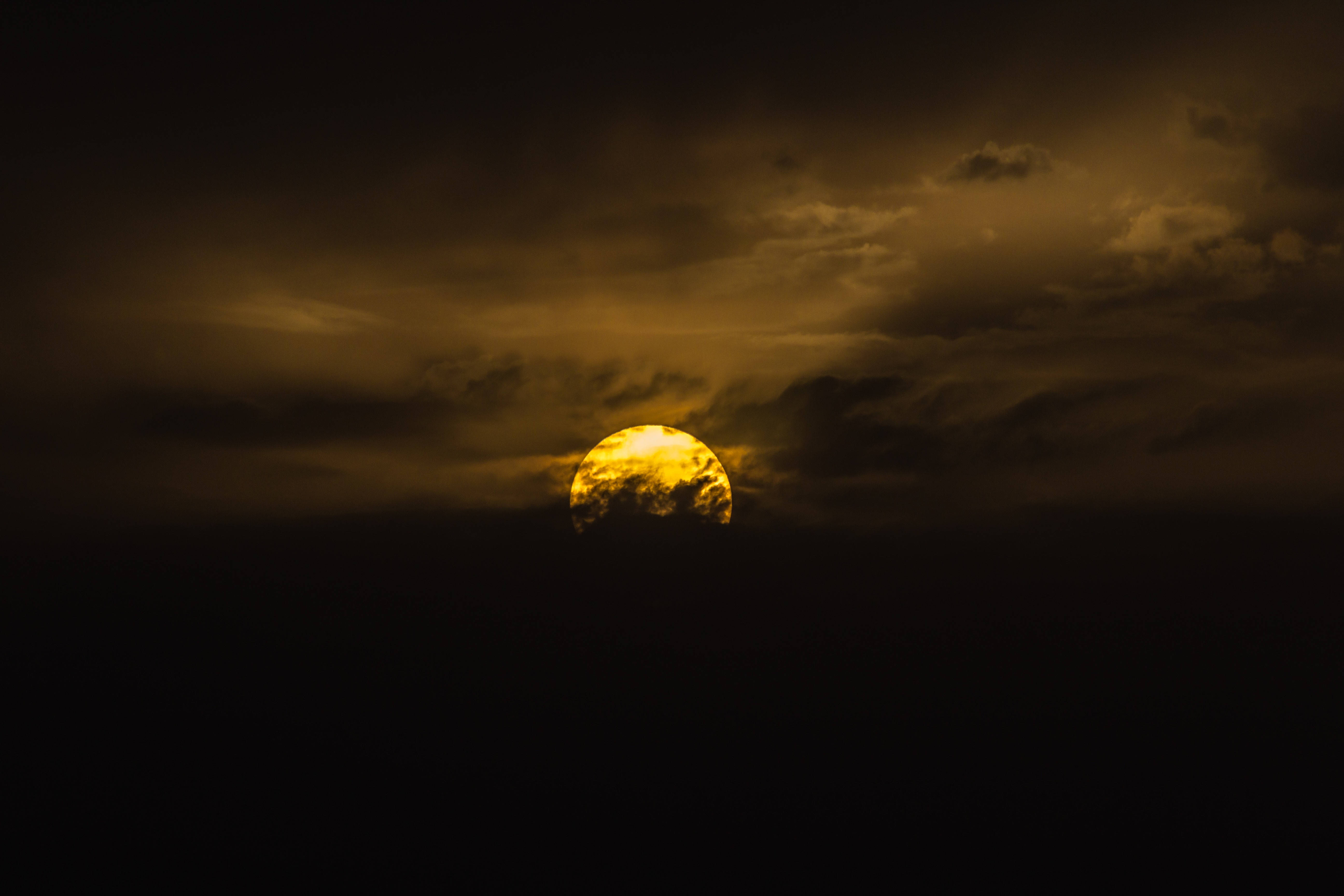 yellow sun, dark clouds, glowing golden sun, 5K Desktop Wallpaper