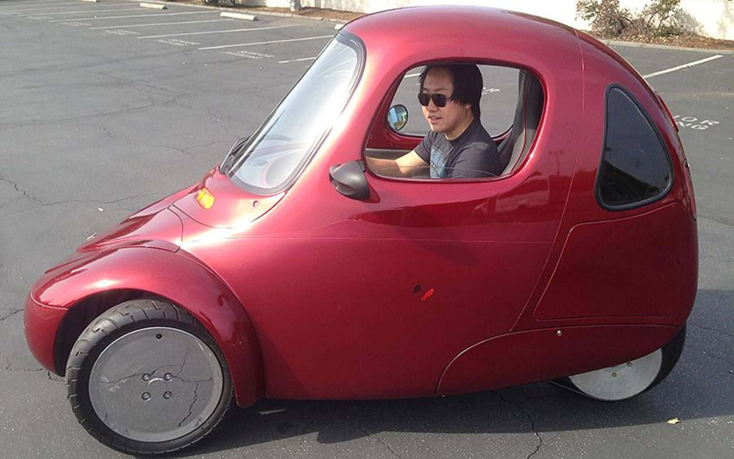 compact red pod car, shiny red, three-wheeled microcar, 2K Desktop Wallpaper
