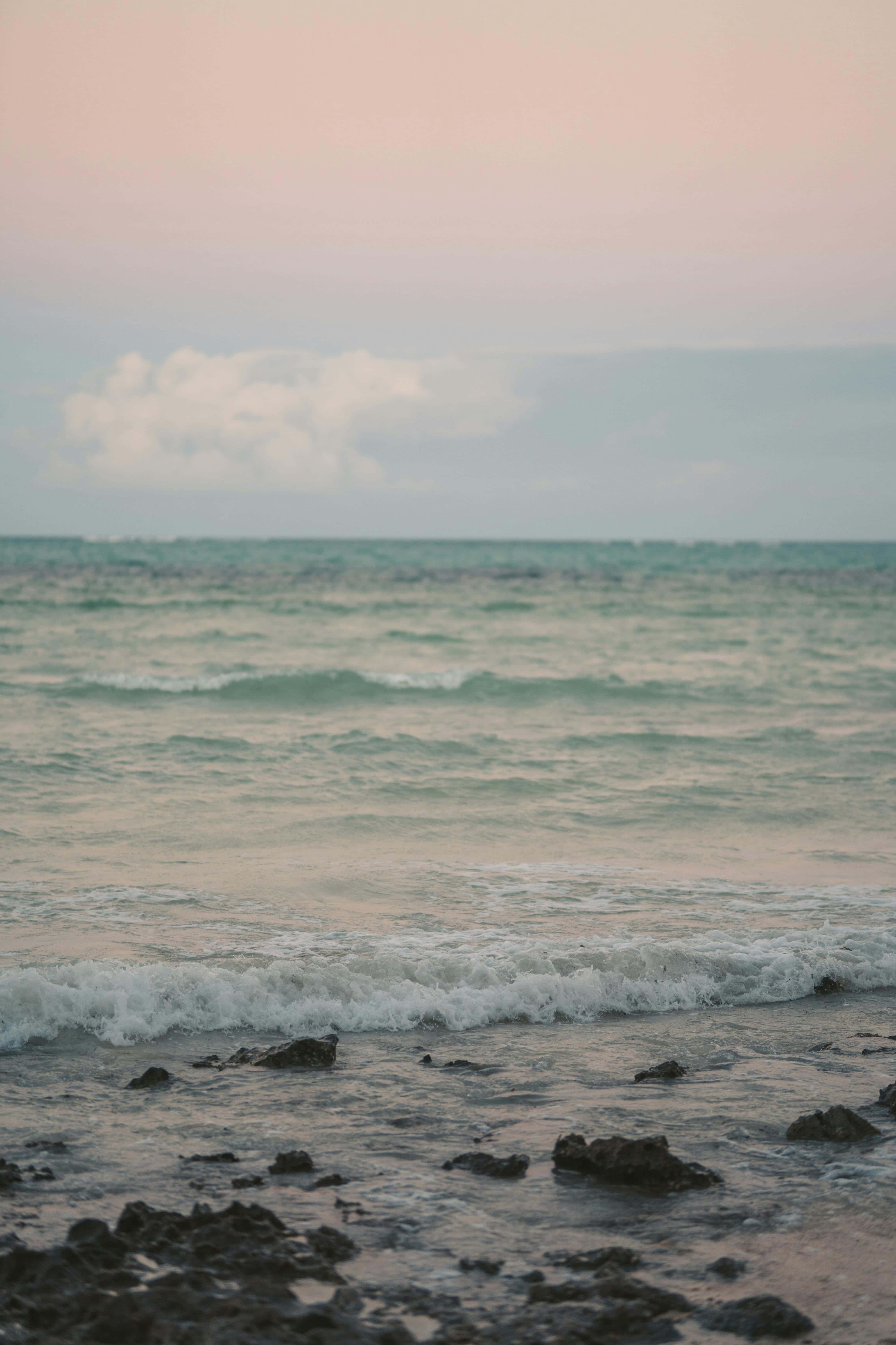serene beach sunset glow, soft pink, teal waves, 5K Phone Wallpaper
