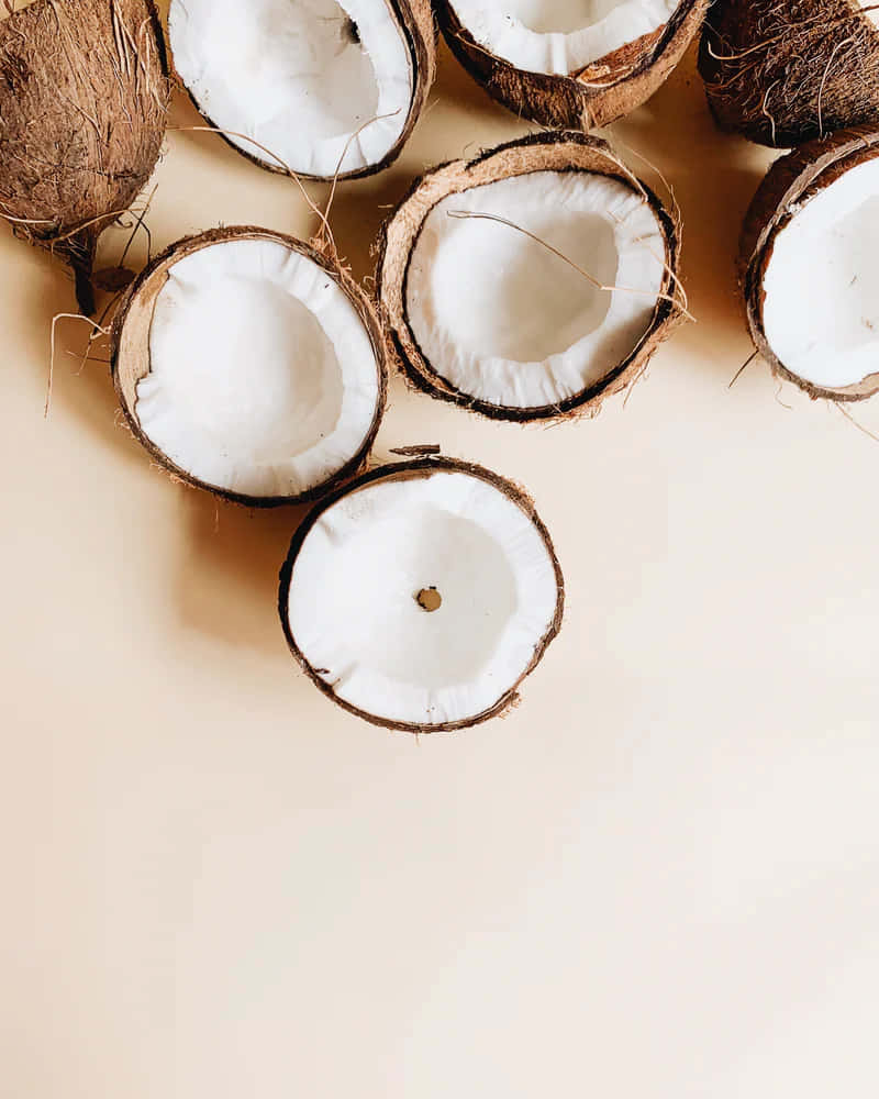 halved coconuts, fibrous brown shells, creamy white interiors, SD Phone Wallpaper