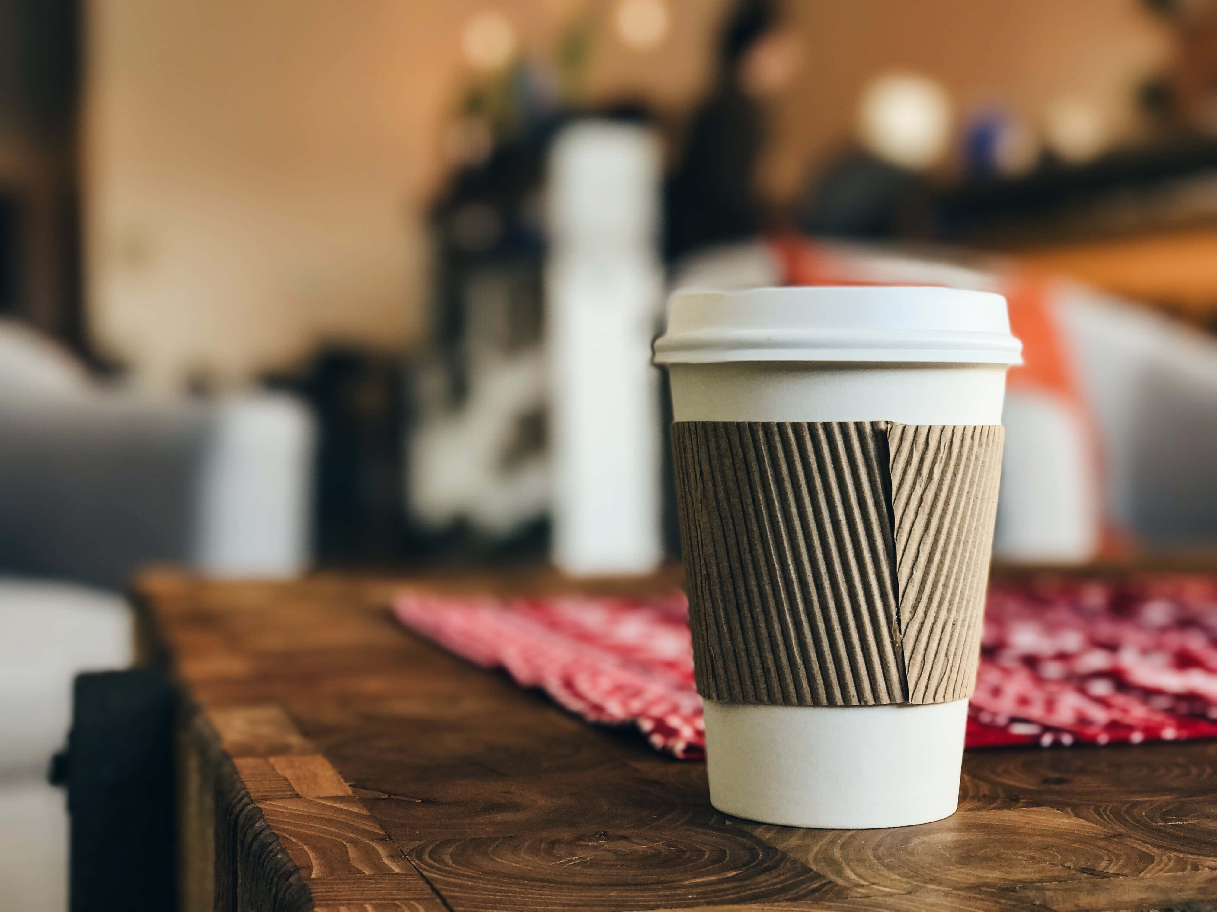 white coffee cup, brown ribbed sleeve, rustic wooden table, 4K Desktop Wallpaper