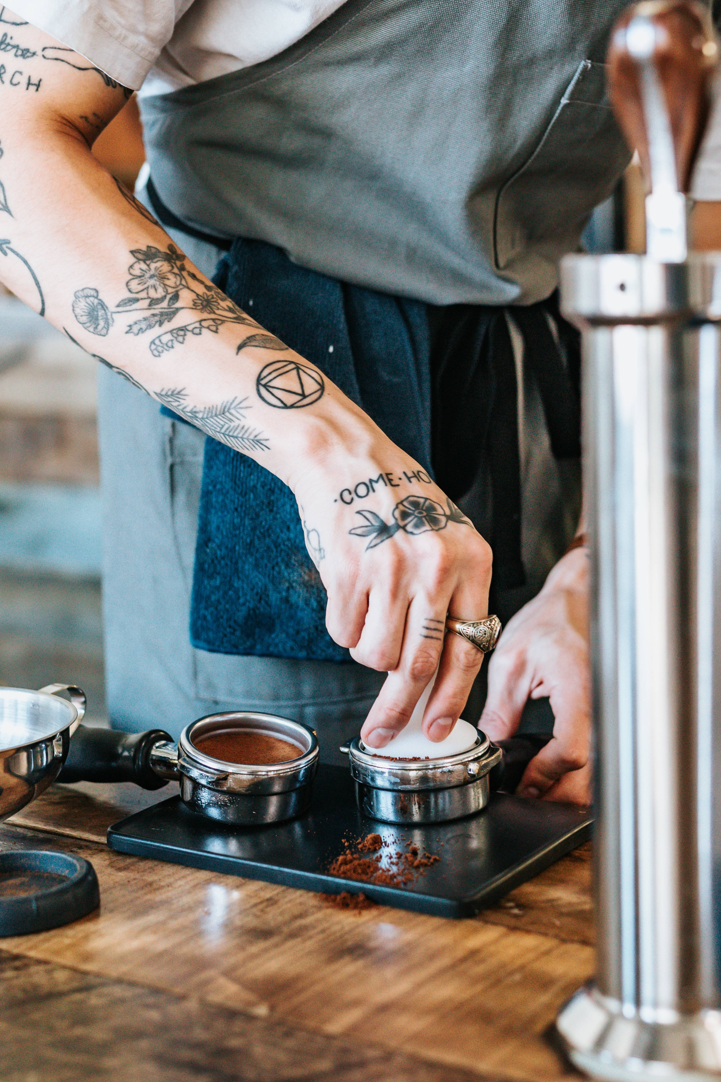 barista, tattooed arms, tamps coffee grounds, 4K Phone Wallpaper