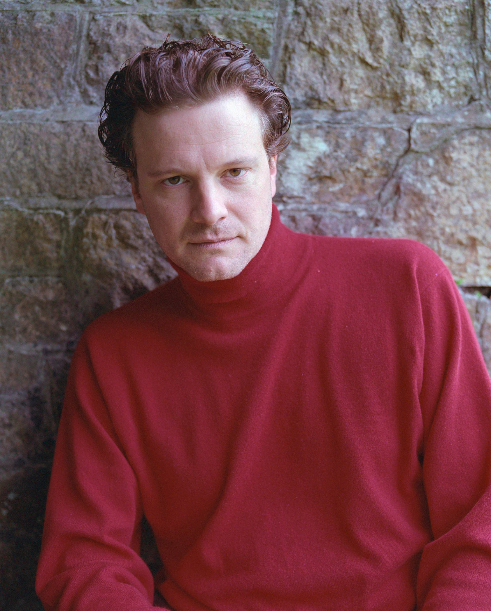Colin Firth, red turtleneck sweater, textured stone wall, Full HD Phone Wallpaper