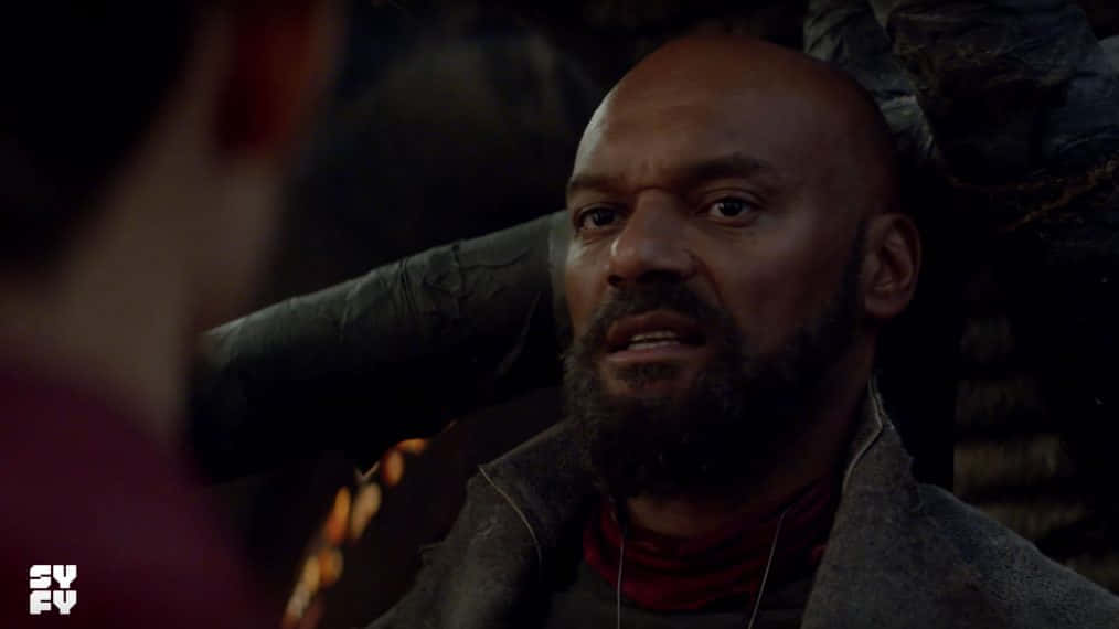 Colin Salmon, dimly lit scene, warm glowing embers, SD Desktop Wallpaper