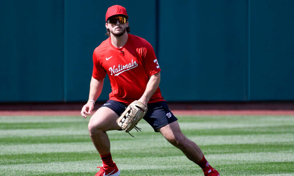 red Nationals gear, sunlit green field, teal wall, SD Desktop Wallpaper