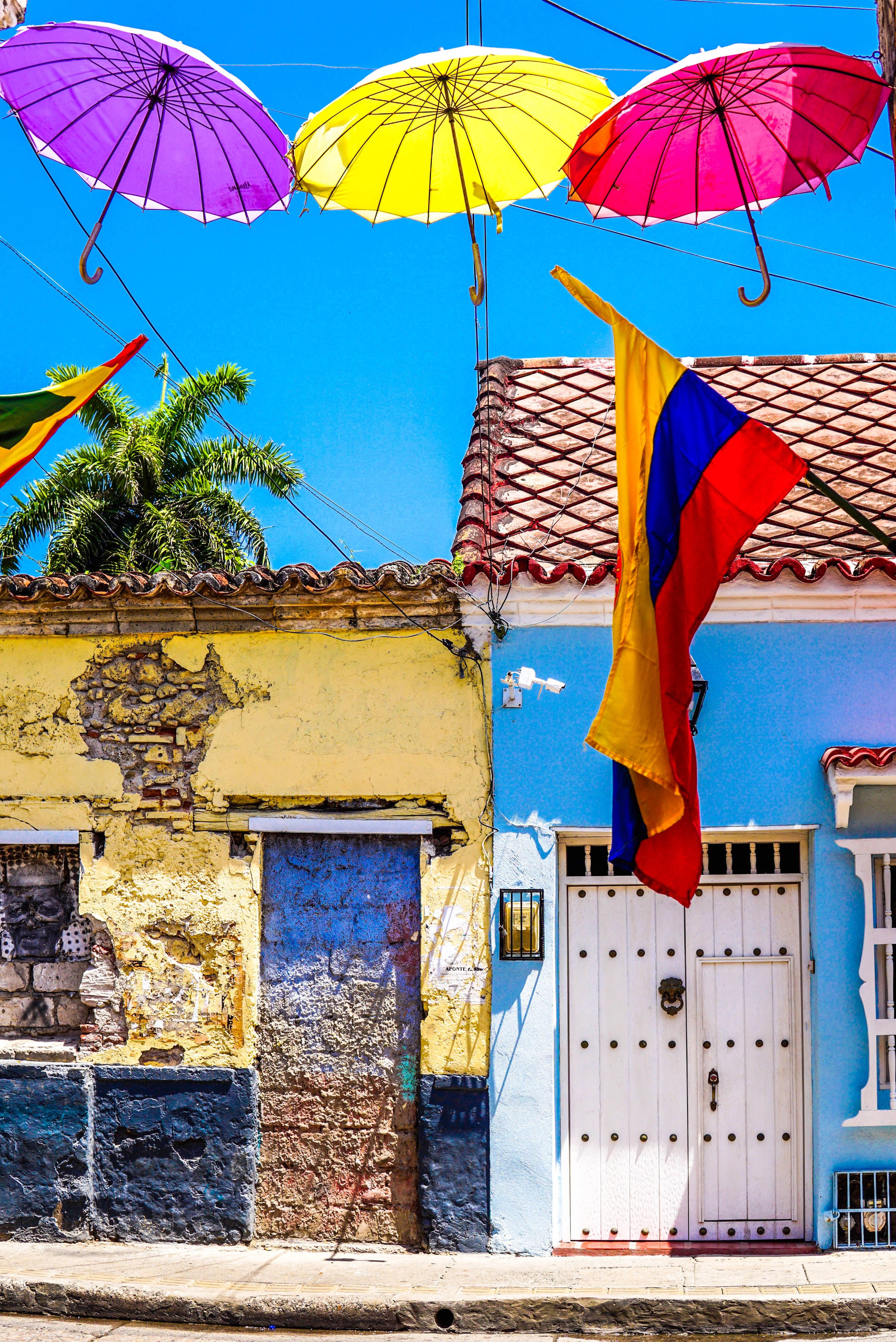 Colombia flag, village, purple yellow and pink umbrellas, 2K Phone Wallpaper