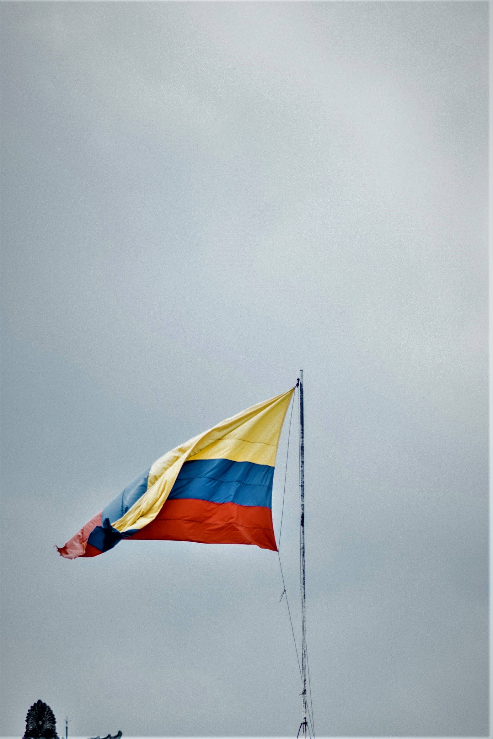 Colombia flag, yellow blue and red stripes, muted gray sky, Full HD Phone Wallpaper