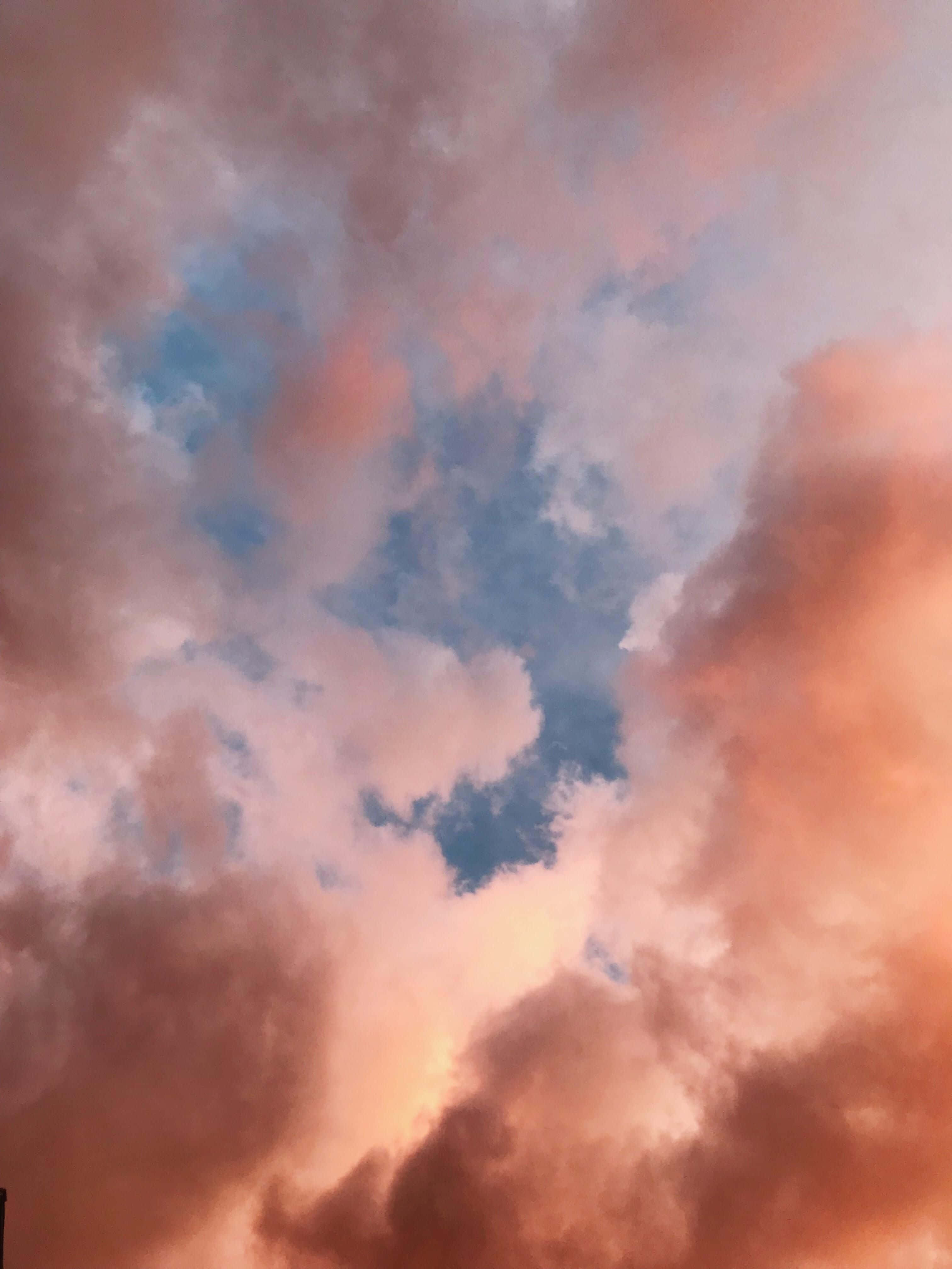 mellow sunset horizon, vibrant sunset clouds, warm orange and pink hues, 4K Phone Wallpaper