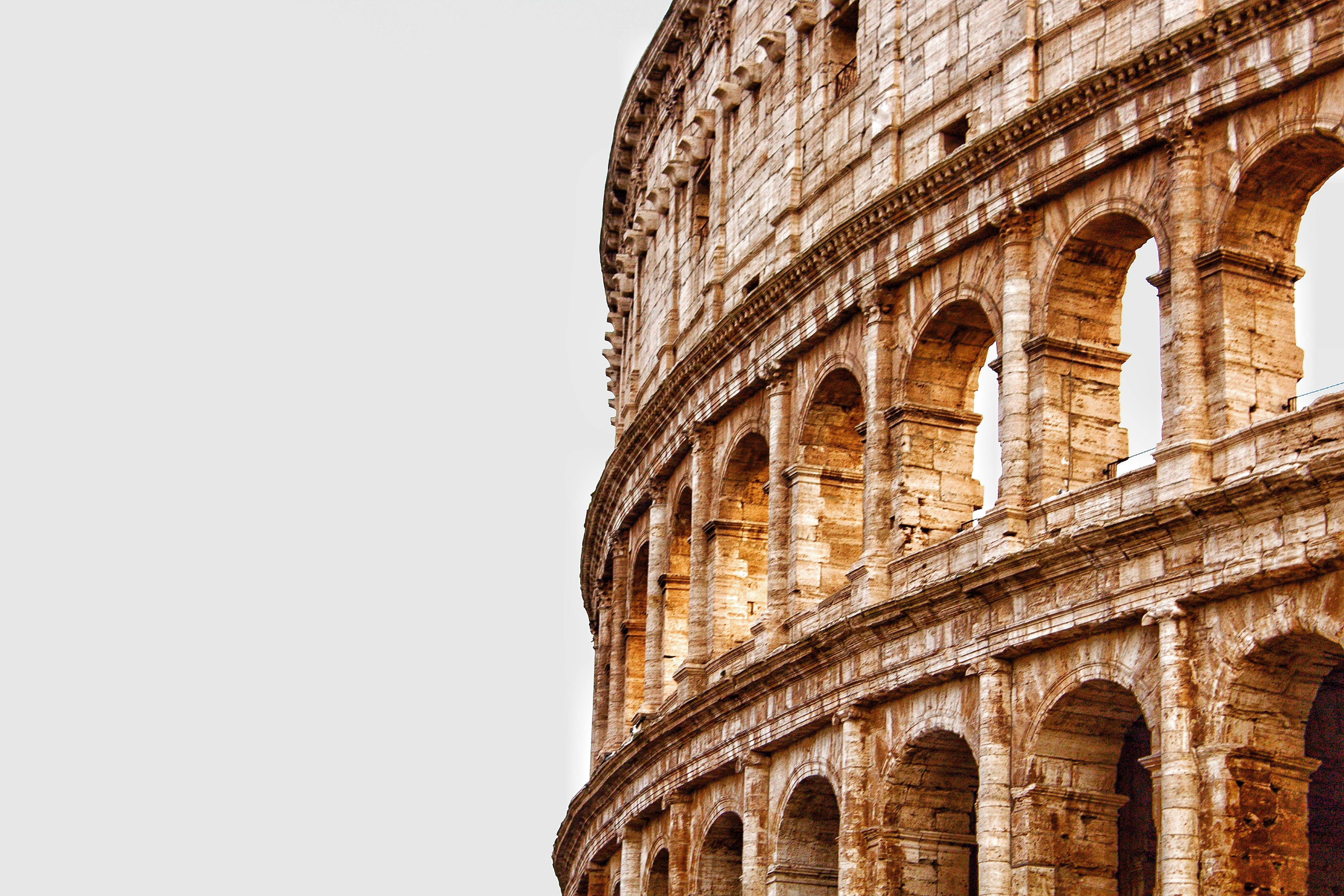 Colosseum, weathered stone arches, pale sky, 5K Desktop Wallpaper