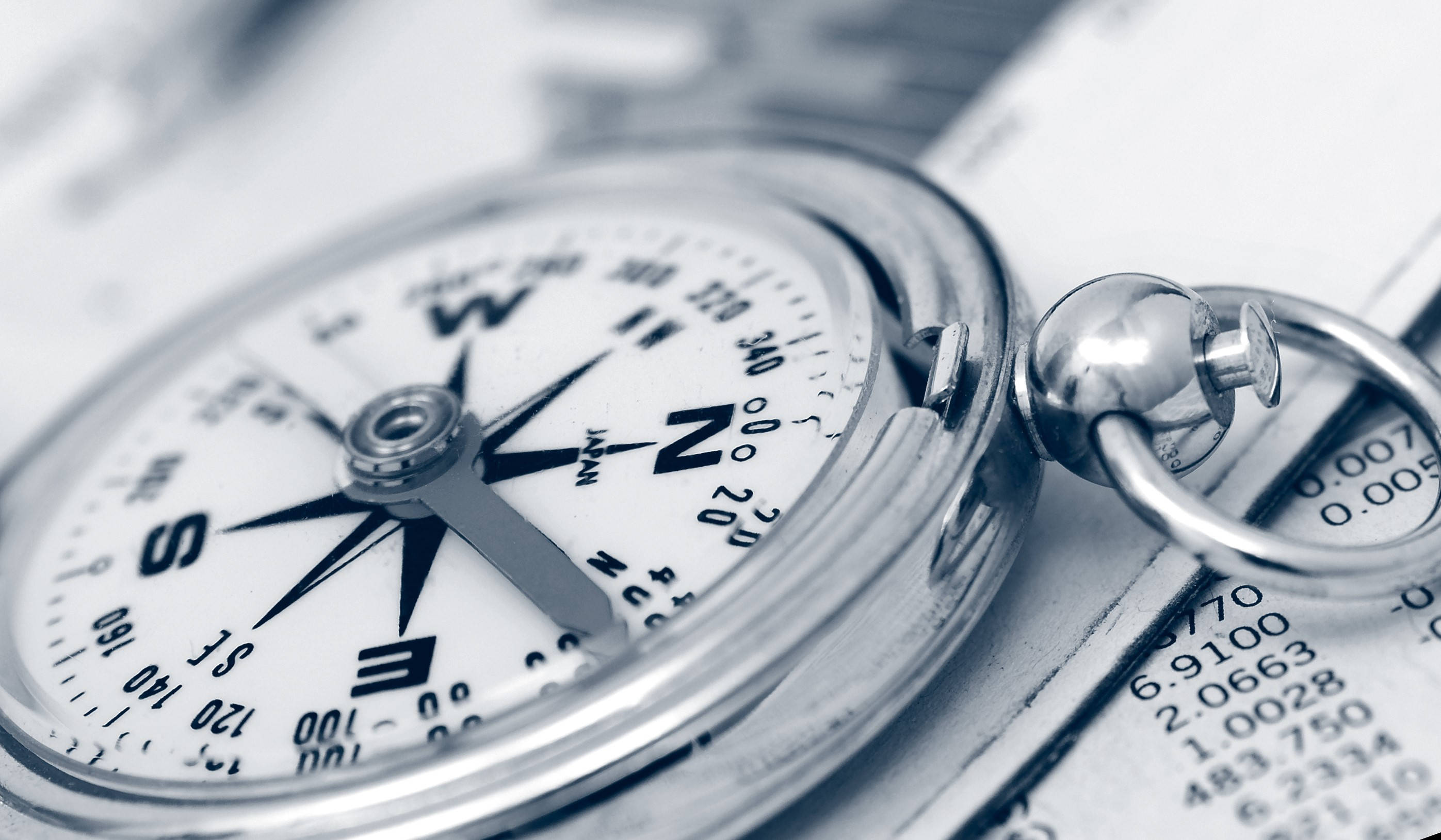 silver compass, document with financial figures, monochrome tones, 2K Desktop Wallpaper