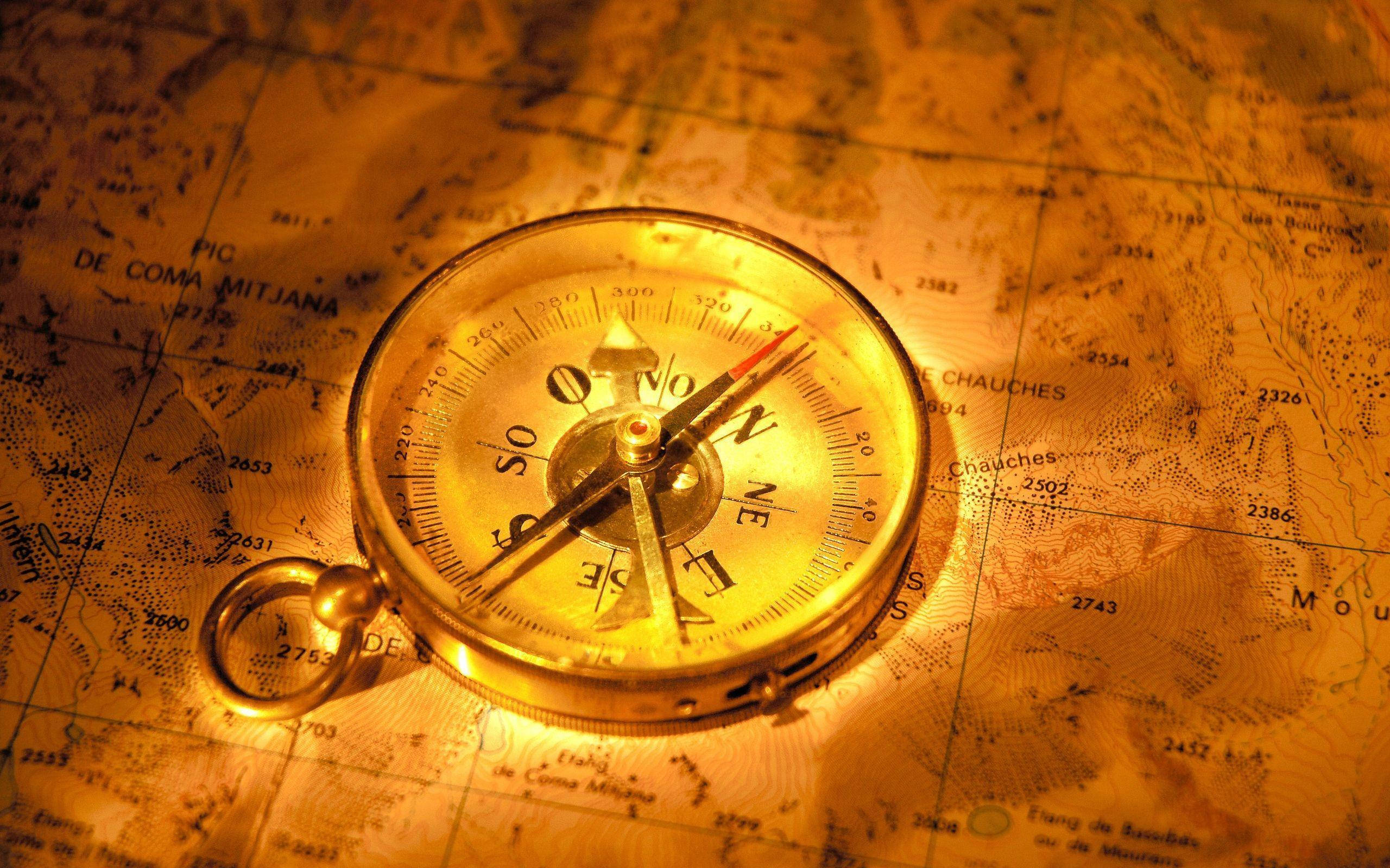 vintage brass compass, antique topographic map, golden light, 2K Desktop Wallpaper