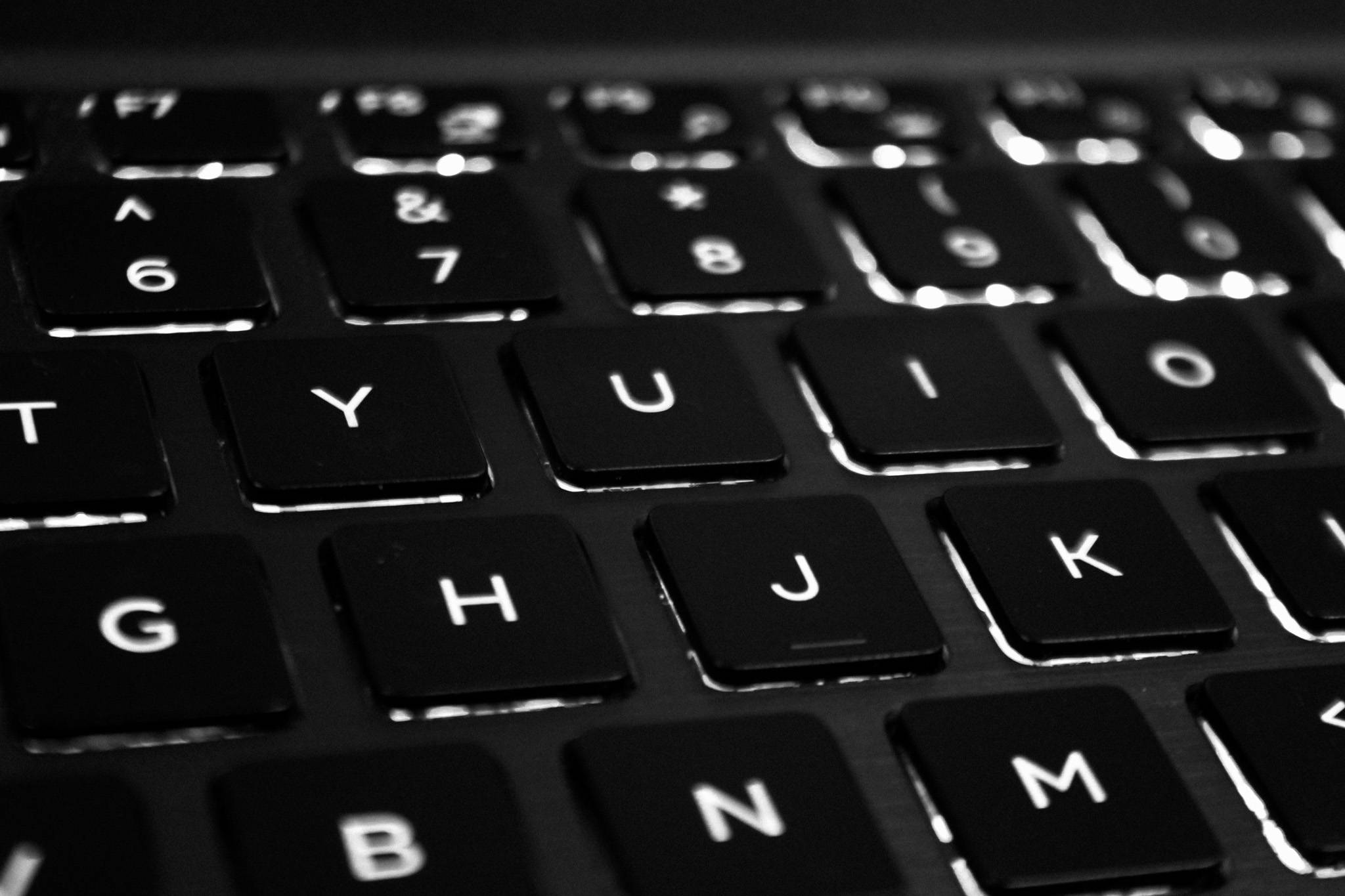 sleek black matte computer keyboard, laptop keyboard, glowing backlighting, Full HD Desktop Wallpaper