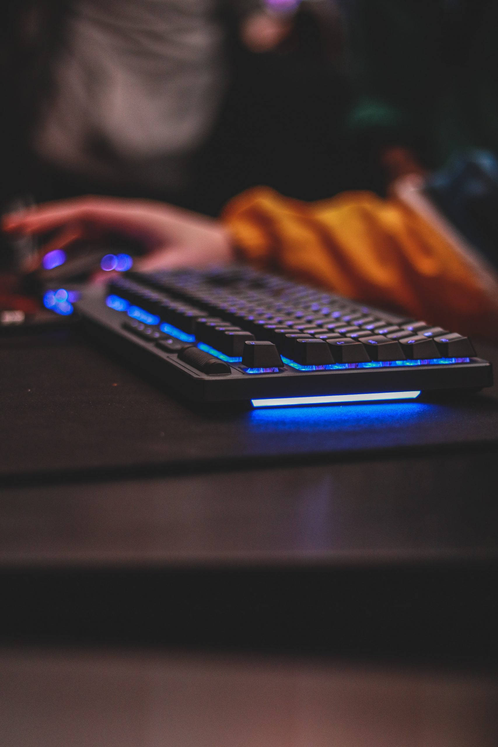 cool blue light computer keyboard, glowing blue mechanical keyboard, dimly lit gaming setup, 2K Phone Wallpaper
