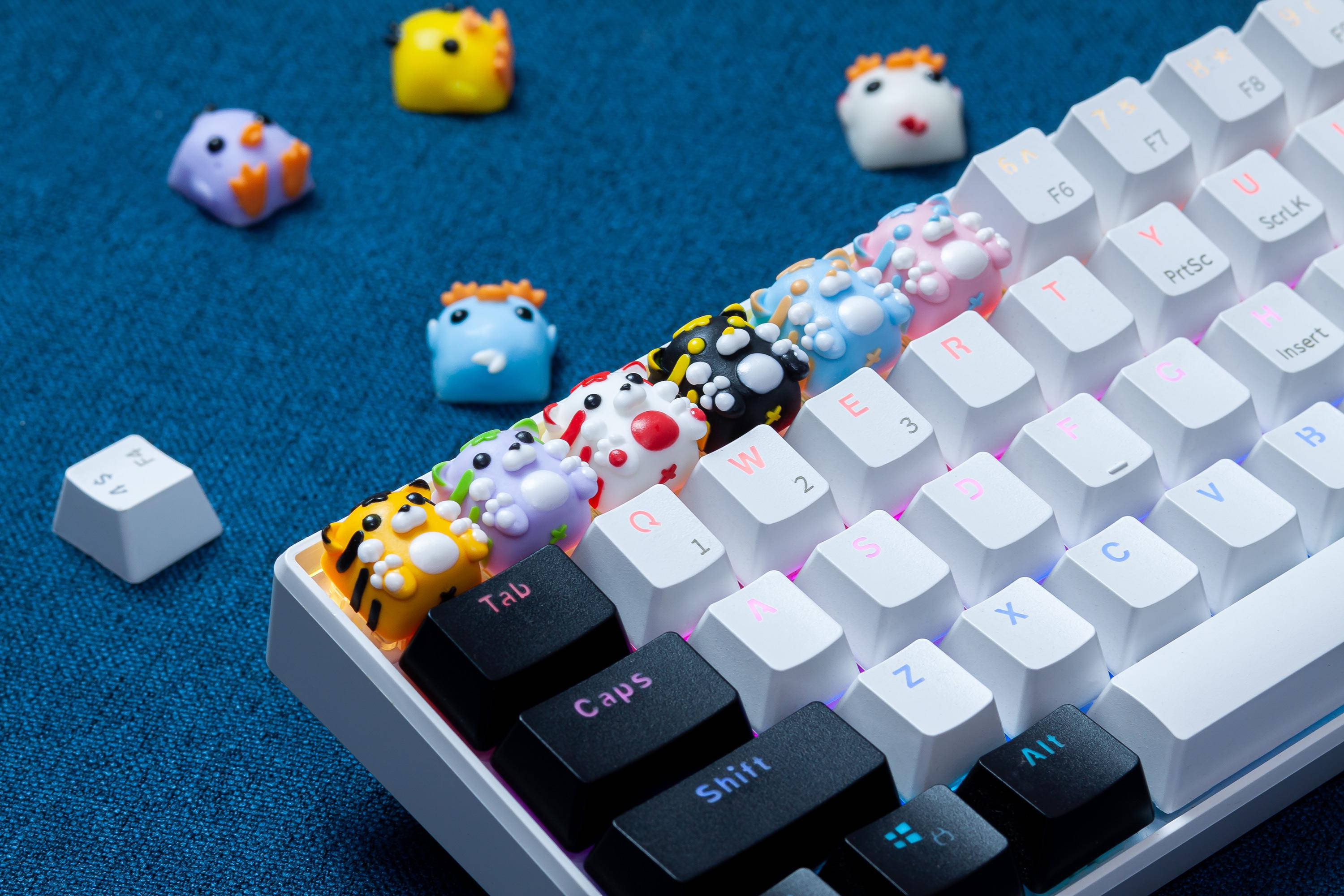 white mechanical keyboard, colorful cartoon character keycaps, textured blue surface, 2K Desktop Wallpaper
