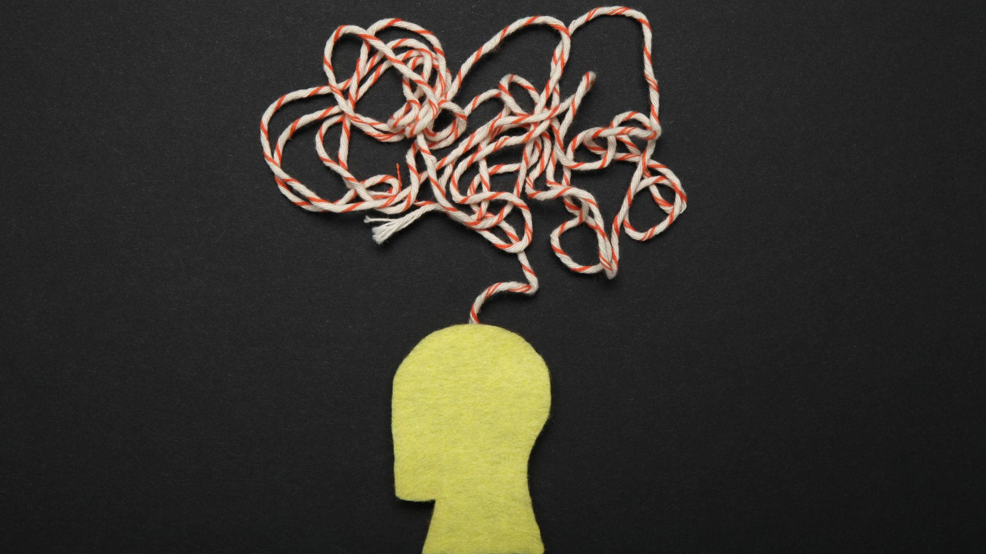 yellow felt head silhouette, tangled red and white rope, black background, Full HD Desktop Wallpaper