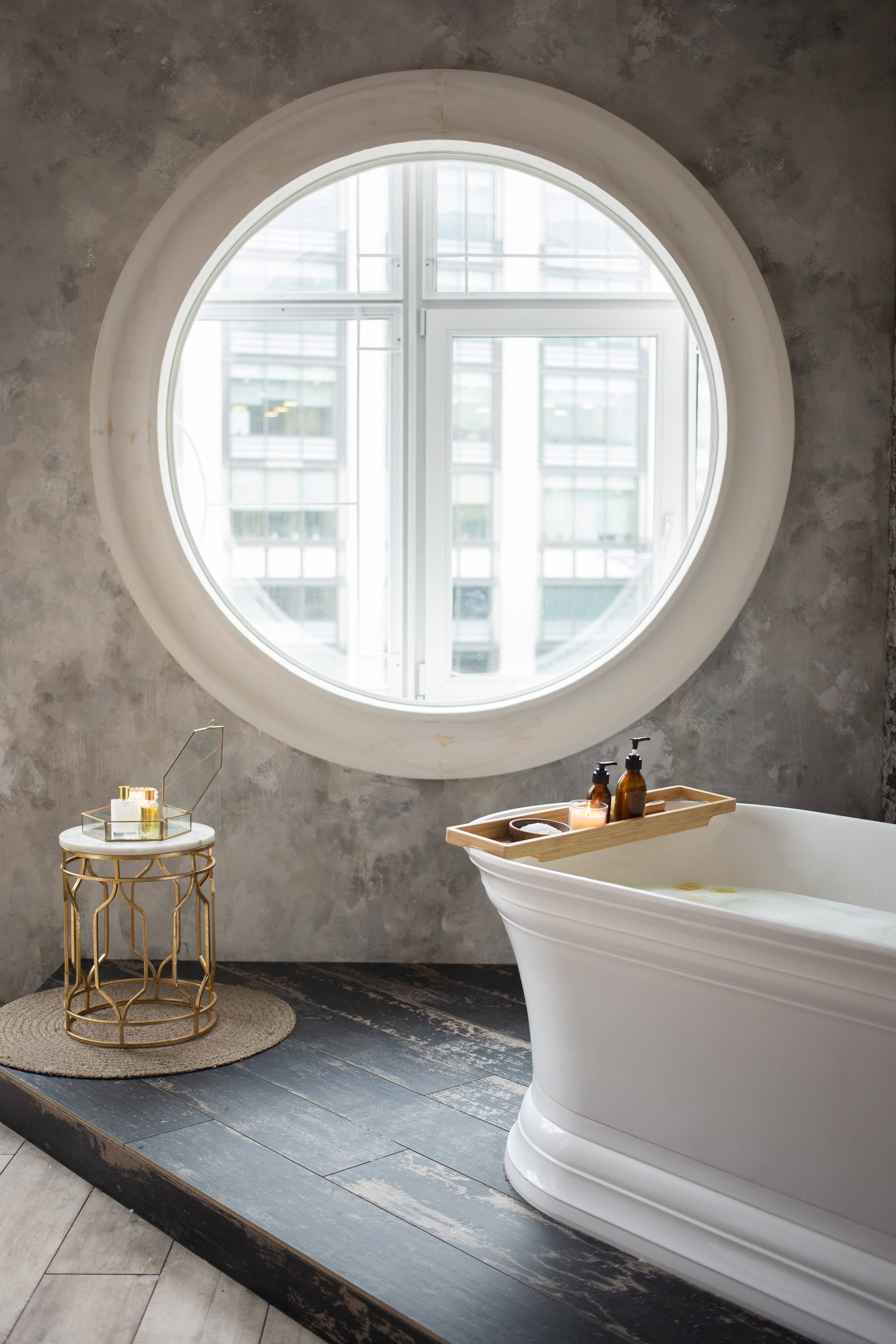 white freestanding bathtub, large round window, city buildings, 5K Phone Wallpaper