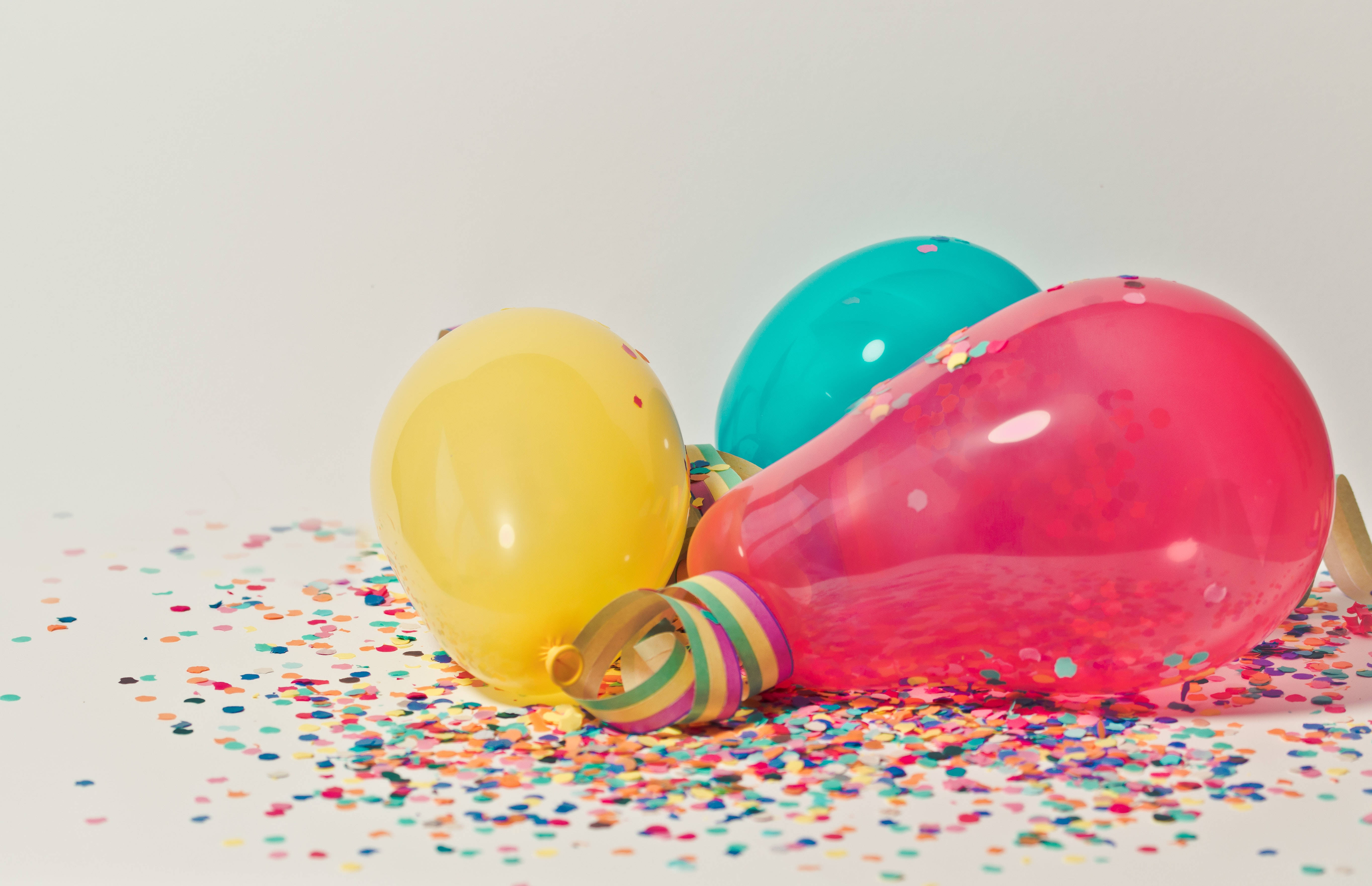 colorful confetti-filled balloons, rainbow glitter, plain white background, 5K Desktop Wallpaper