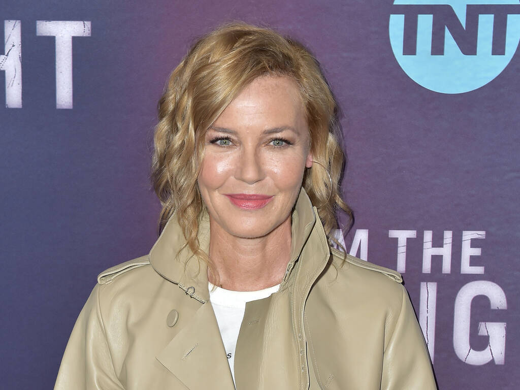Connie Nielsen, beige trench coat, purple TNT branded backdrop, SD Desktop Wallpaper