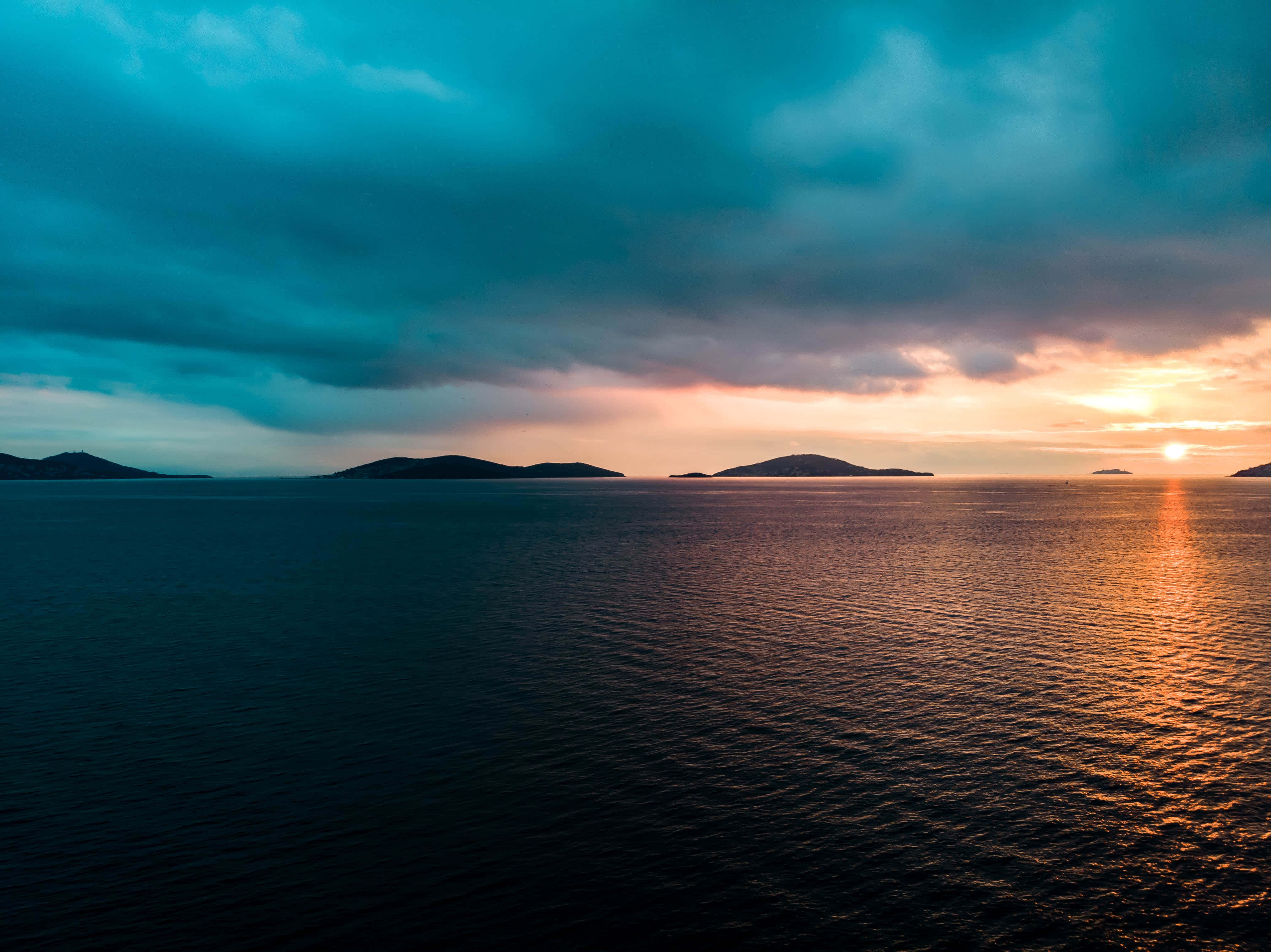 Sunset, calm ocean, distant islands, 4K Desktop Wallpaper