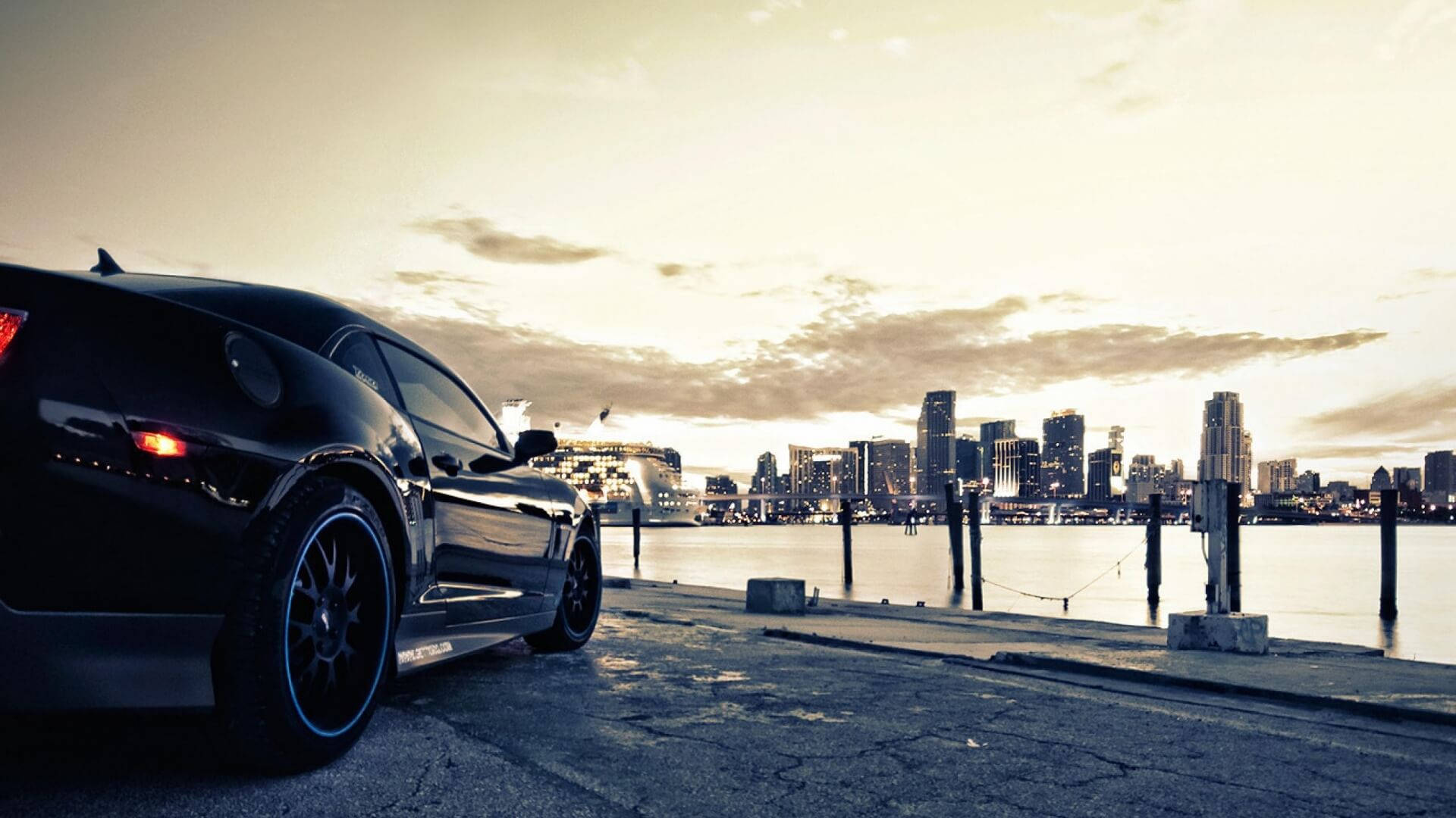 sleek black sports car, waterfront pier, sunset, Full HD Desktop Wallpaper