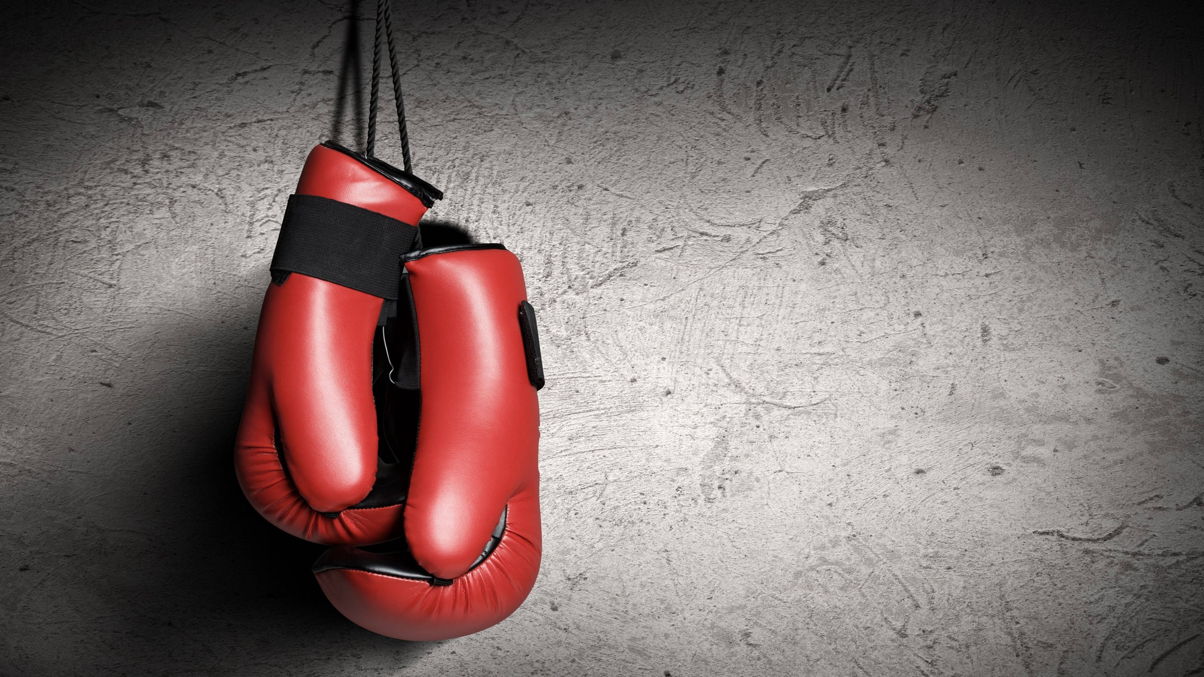 red boxing gloves, black laces, textured gray concrete wall, 4K Desktop Wallpaper