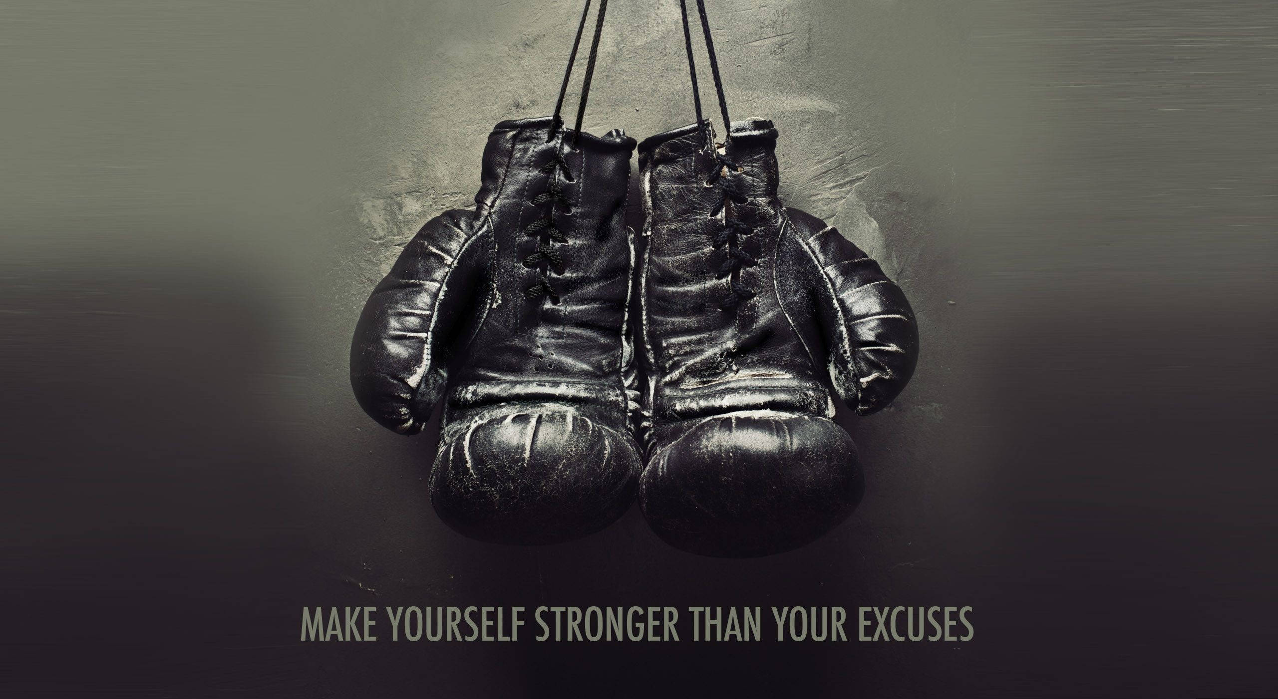 black and white poster, worn black boxing gloves, muted gray wall, 2K Desktop Wallpaper