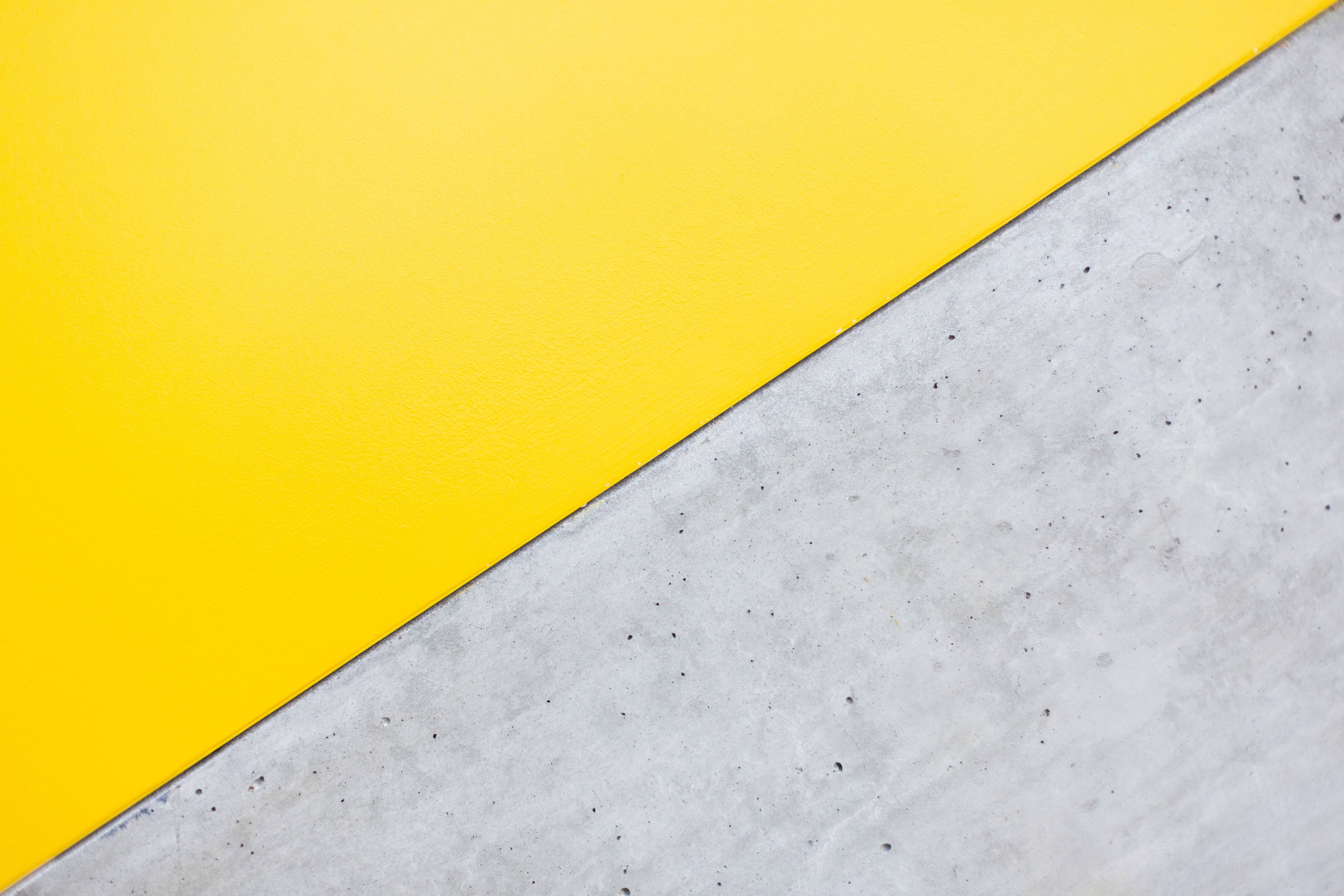yellow aesthetic computer, vibrant yellow surface, textured gray concrete, 5K Desktop Wallpaper
