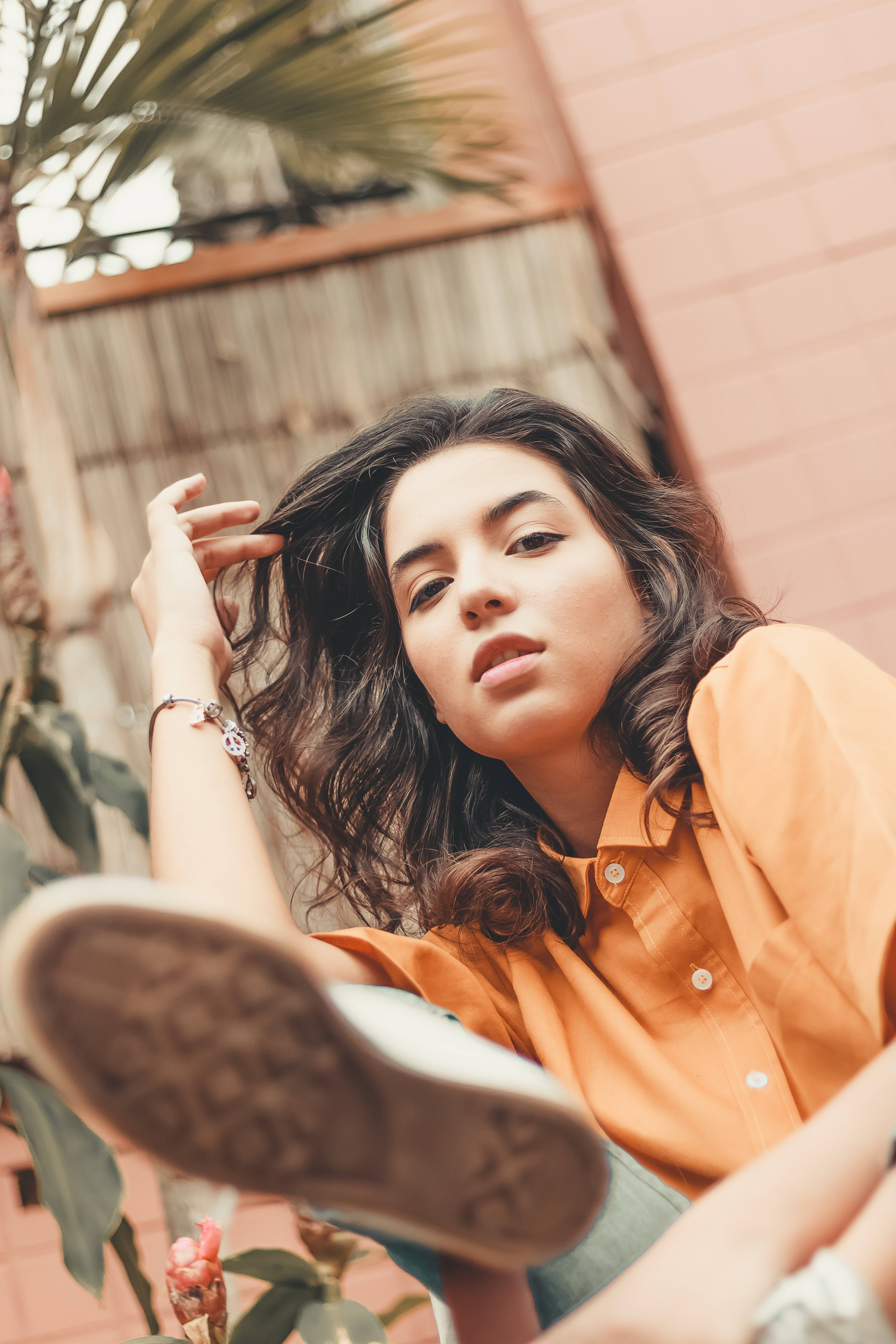 Cool Latina Girl, orange shirt, pink brick wall, 5K Phone Wallpaper