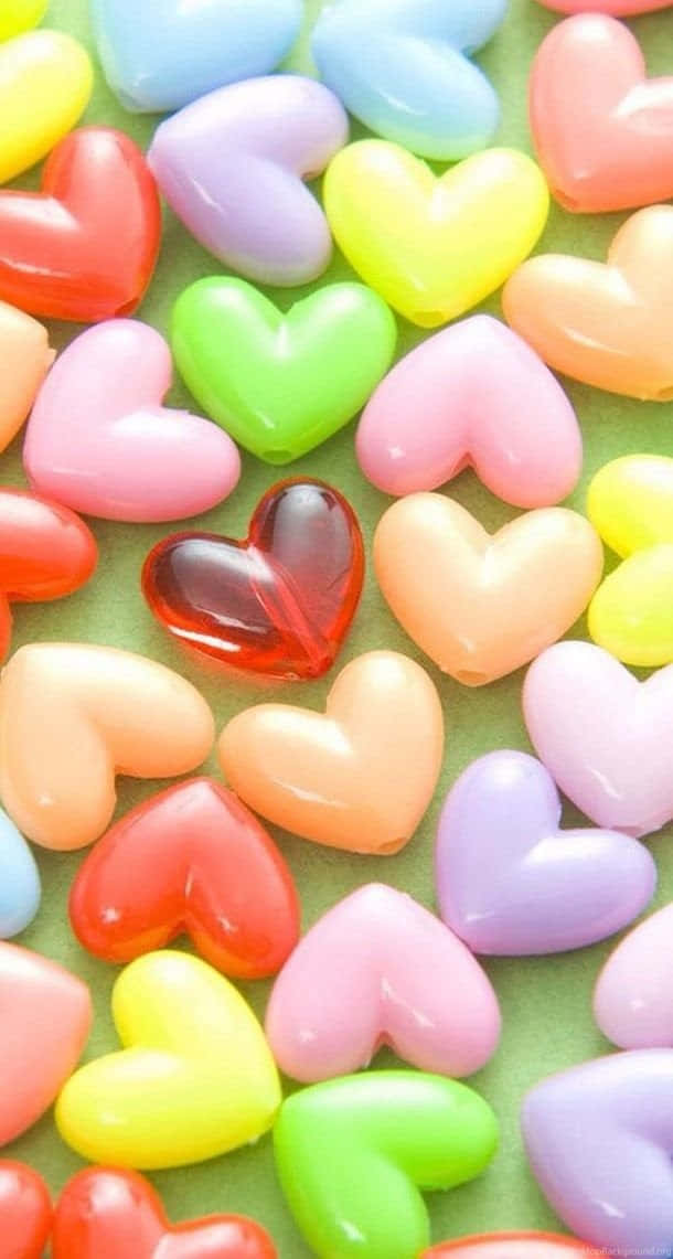 cool girly, glossy multicolored heart-shaped candies, green surface, SD Phone Wallpaper